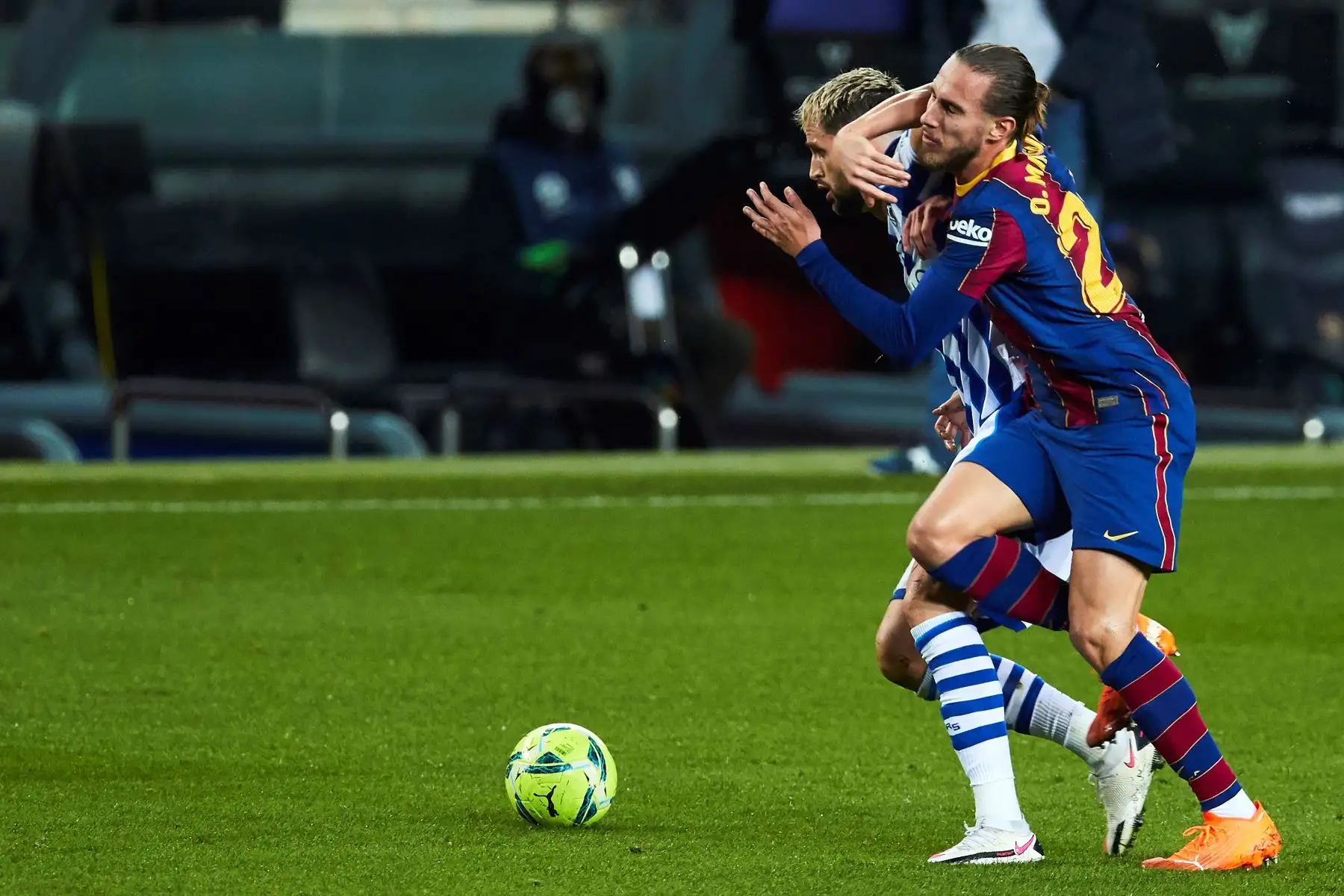 El defensa del FC Barcelona Óscar Mingueza pelea la posesión del balón con el centrocampista belga de la Real Sociedad Adnan Januzaj durante un encuentro correspondiente a la decimonovena jornada de la LaLiga Santander. Foto: EFE