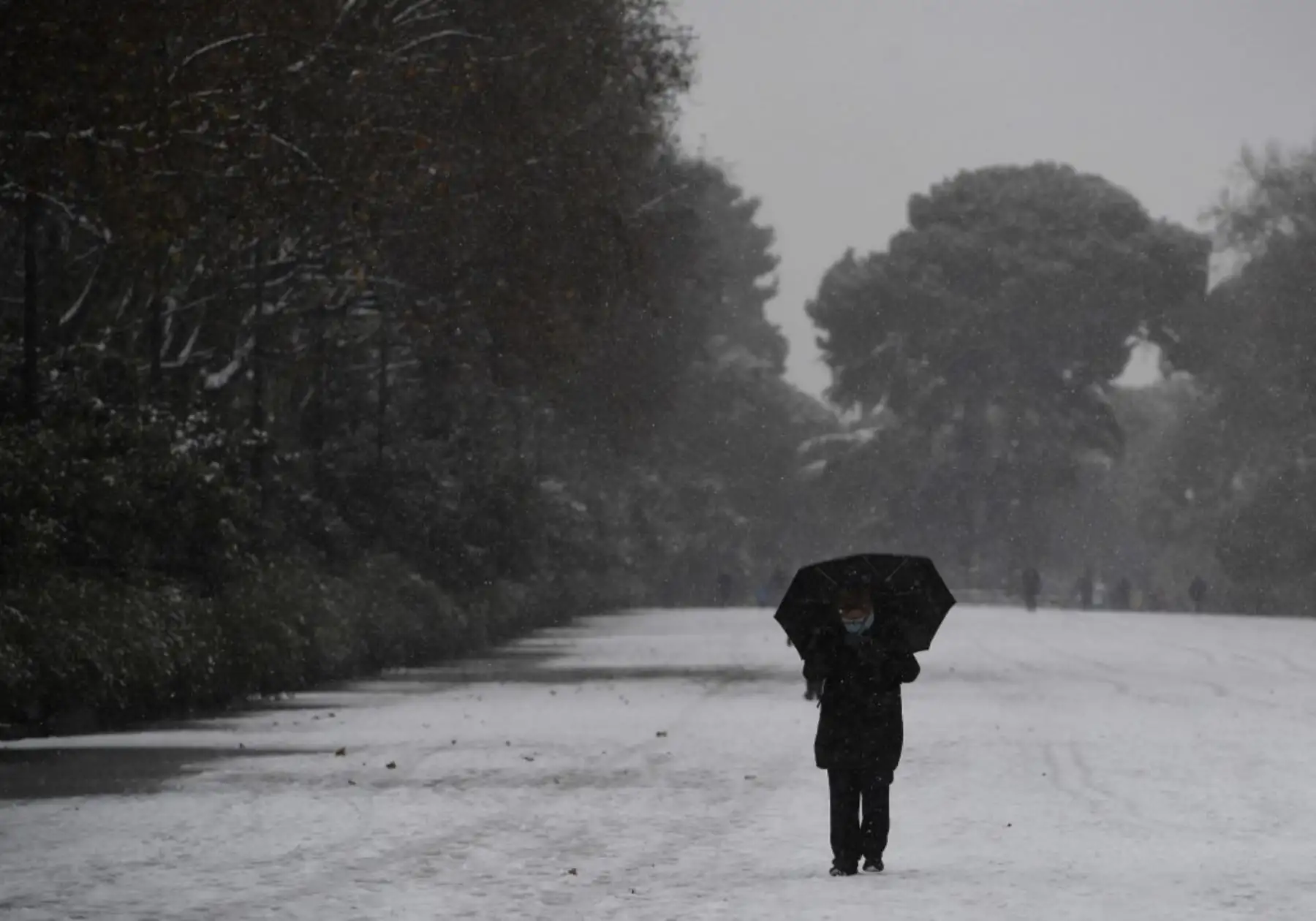 Una persona camina mientras cae la nieve en Madrid el 8 de enero de 2021. Hoy en día, fuertes nevadas cayeron en gran parte de España, dejando enormes áreas cubiertas de blanco cuando la tormenta Filomena trajo un clima invernal no visto en décadas a la península ibérica. Foto: AFP