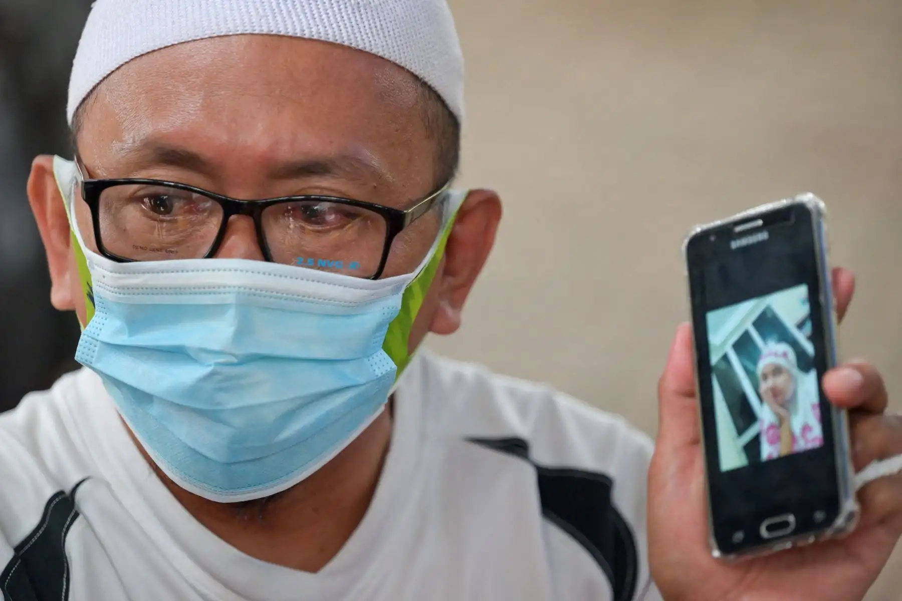 Rafik Al-Idrus muestra una foto de su esposa, una de las 62 personas a bordo del vuelo SJ182 de Sriwijaya Air que se estrelló poco después del despegue el 9 de enero. Foto: AFP