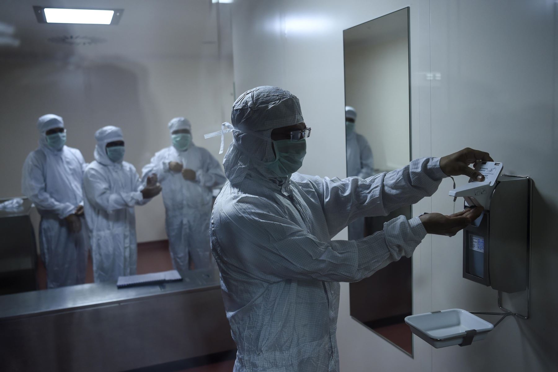 Los empleados se preparan antes de ingresar al laboratorio donde se fabrica Covishield, la vacuna de coronavirus Covid-19 de AstraZeneca-Oxford, en el Serum Institute de India.
Foto : AFP