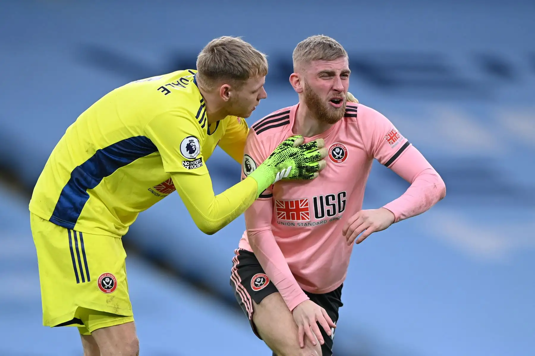 El portero inglés del Sheffield United, Aaron Ramsdale, controla el delantero escocés nacido en Inglaterra del Sheffield United, Oli McBurnie, después de un choque de cabezas durante el partido de fútbol de la Premier League inglesa entre el Manchester City y el Sheffield United.
Foto: AFP