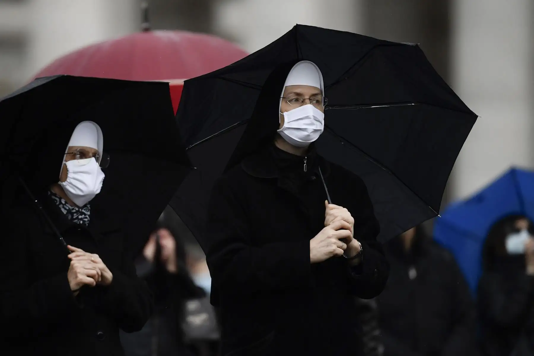 Monjas que llevan una máscara facial asisten bajo la lluvia a la oración semanal del Ángelus del Papa en la Plaza de San Pedro en el Vaticano, durante la pandemia de covid-19.
Foto: AFP