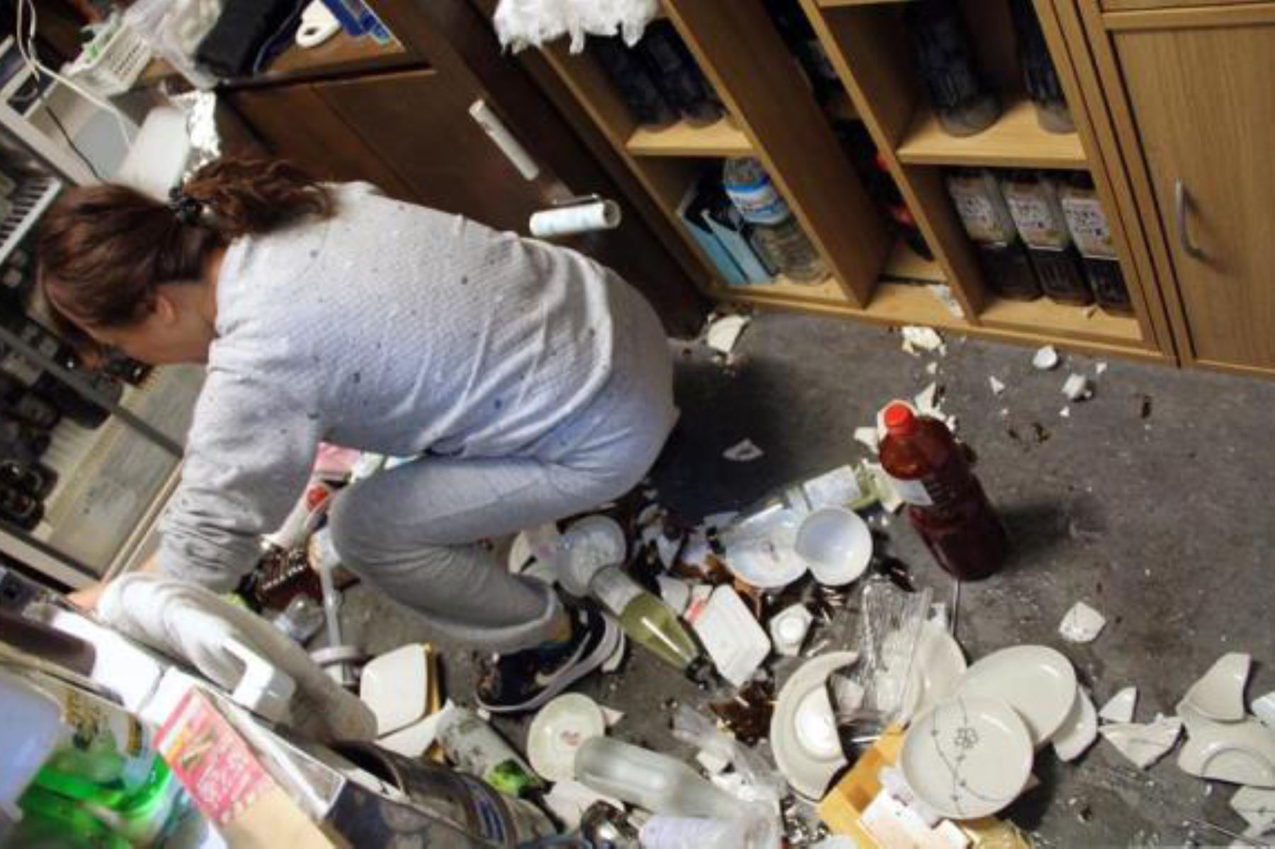 Una mujer limpia platos rotos en un restaurante después de que un fuerte terremoto azotara el noreste de Japón. Foto: EFE