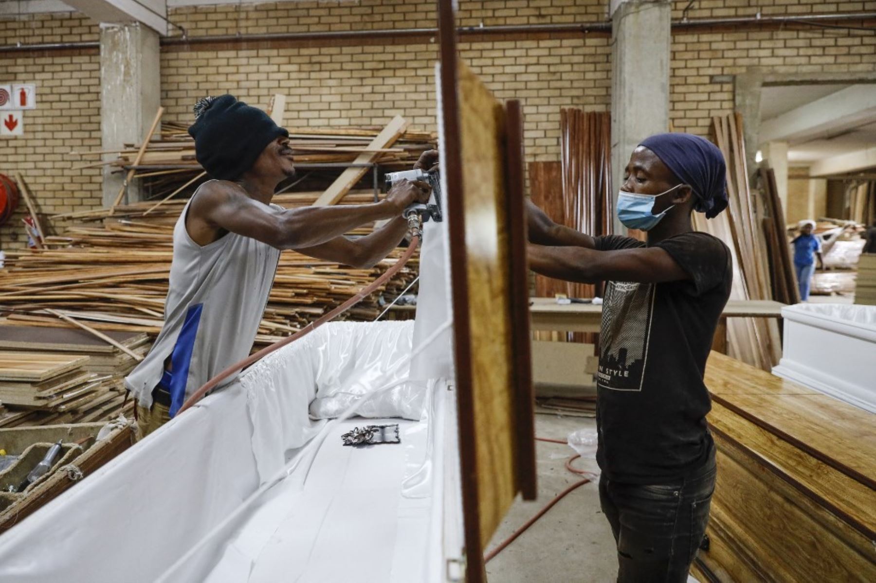 Trabajadores construyen un ataúd de madera en las instalaciones de fabricación de Enzo Wood Designs en Johannesburgo, Sudáfrica. Foto: AFP