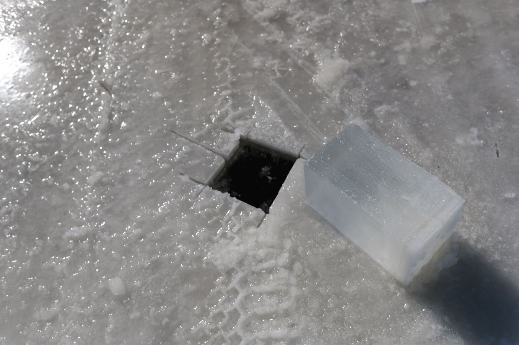 Después de cortarlo, Gilbert Cardin saca un cubo de hielo para verificar la profundidad de la ruta que conecta las ciudades de Pointe-Fortune y Saint-Pointe-Fortune y Saint-Andre-d