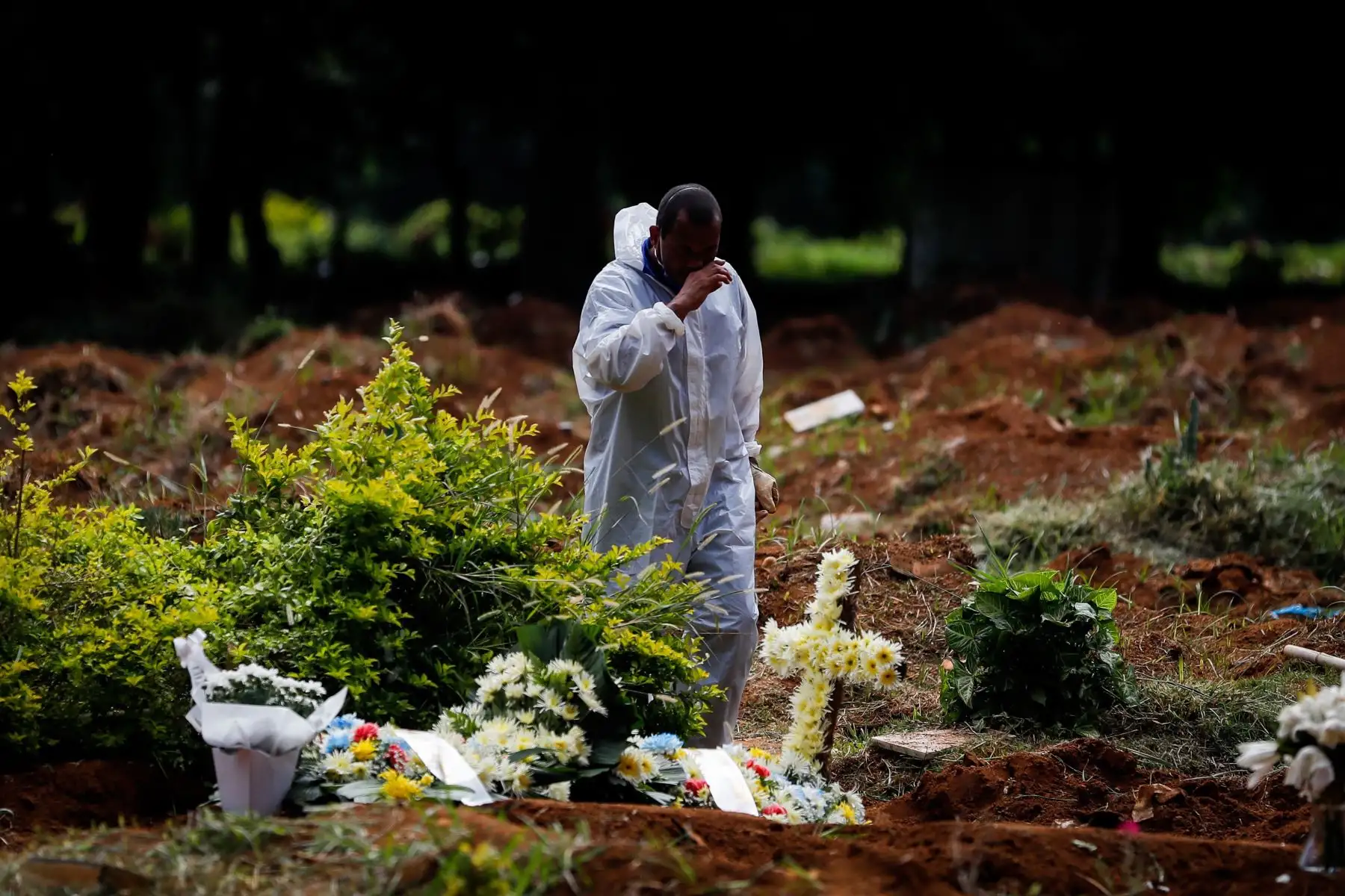 Trabajadores llevan a cabo el entierro de una víctima de la covid-19 en el Cementerio Vila Formosa en Sao Paulo, Brasil. 
Foto :EFE