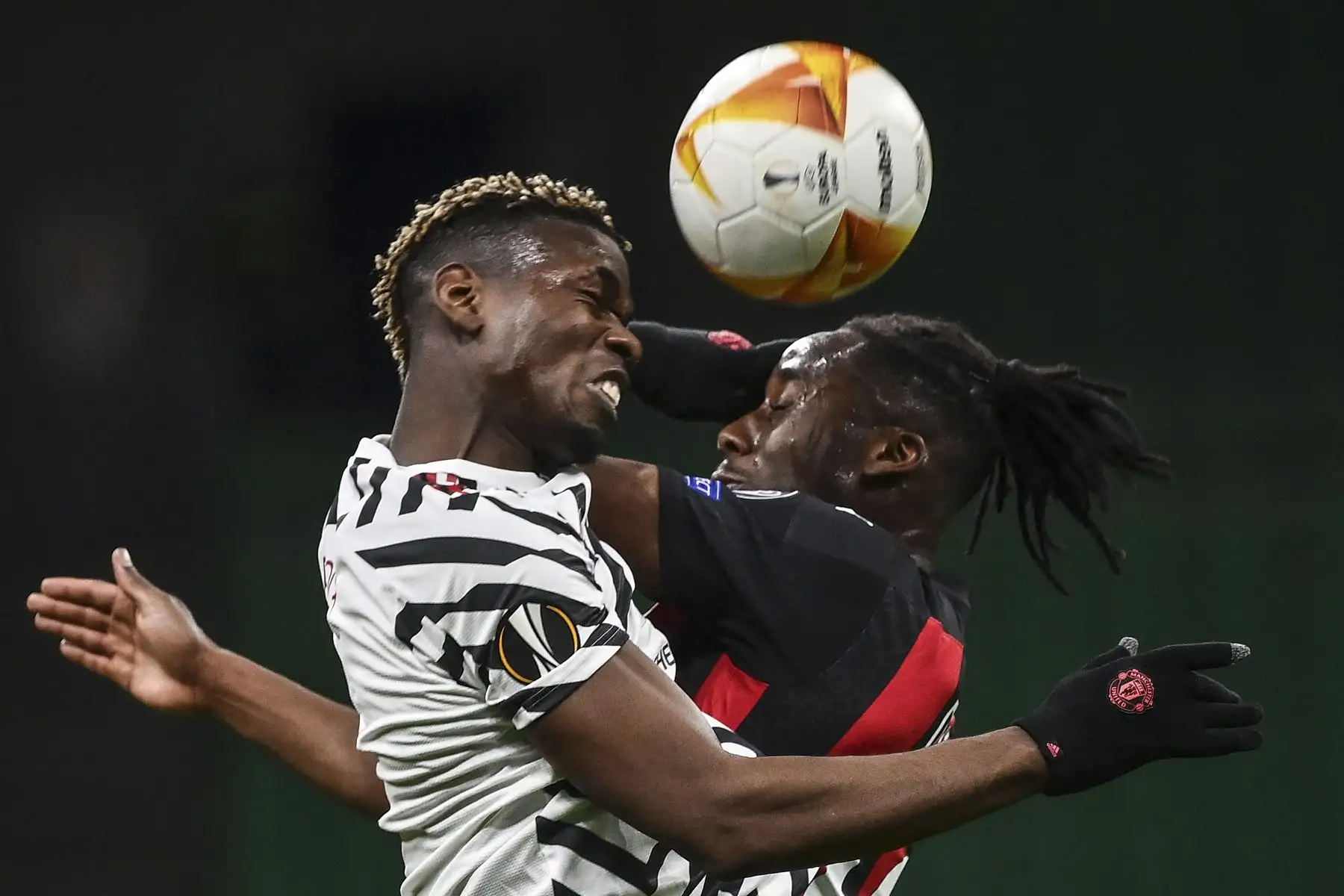 El centrocampista francés del Manchester United Paul Pogba y el mediocampista francés del AC Milan Souhaliho Meite compiten un balón aéreo durante los octavos de final de la UEFA Europa League. Foto: AFP