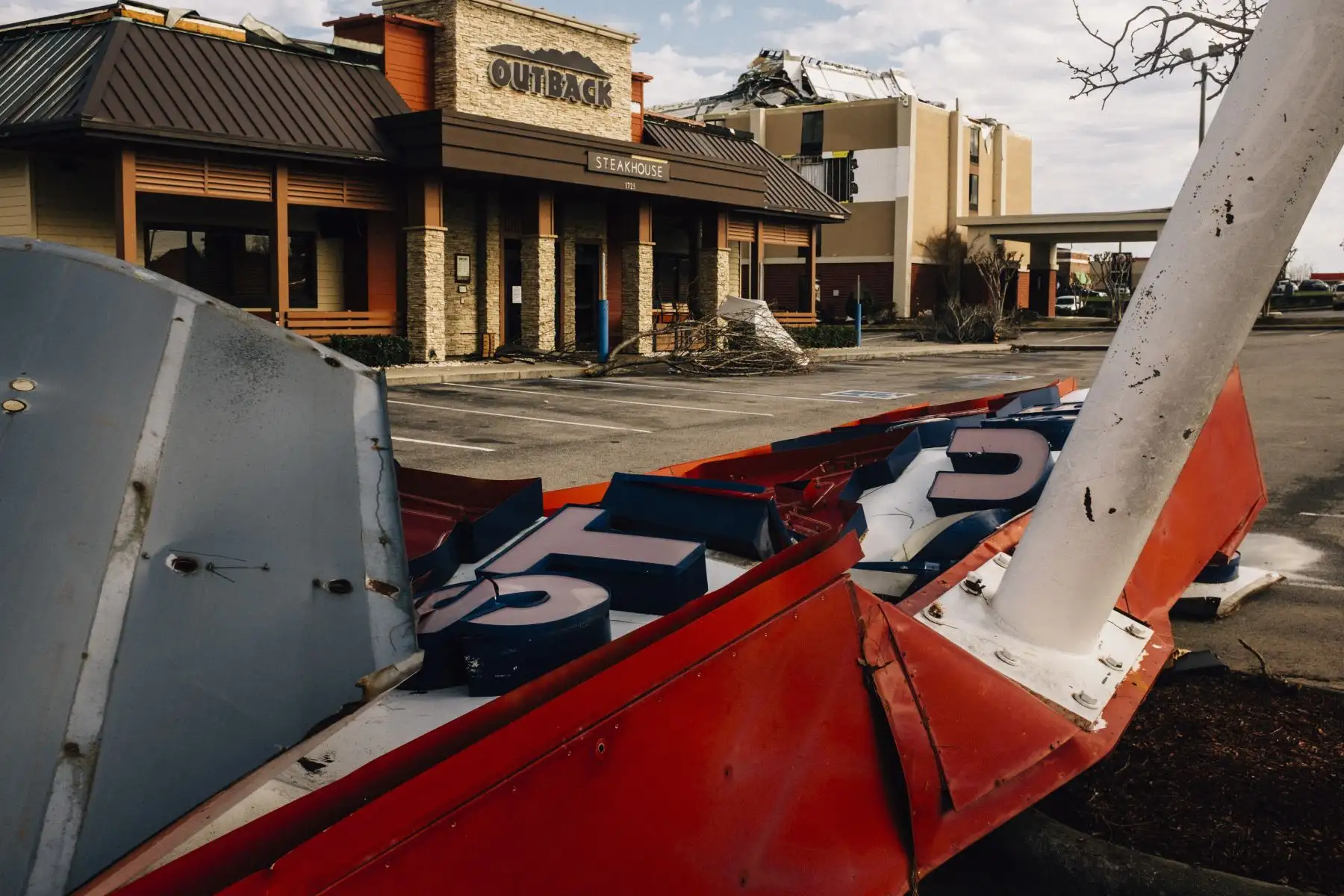 Un letrero de un restaurante yace en el suelo después de sufrir daños por un tornado el 26 de enero de 2021 en Fultondale, Alabama. Un tornado arrasó Fultondale dañando la propiedad y dejando una persona muerta y más de una docena de heridos. Foto: AFP