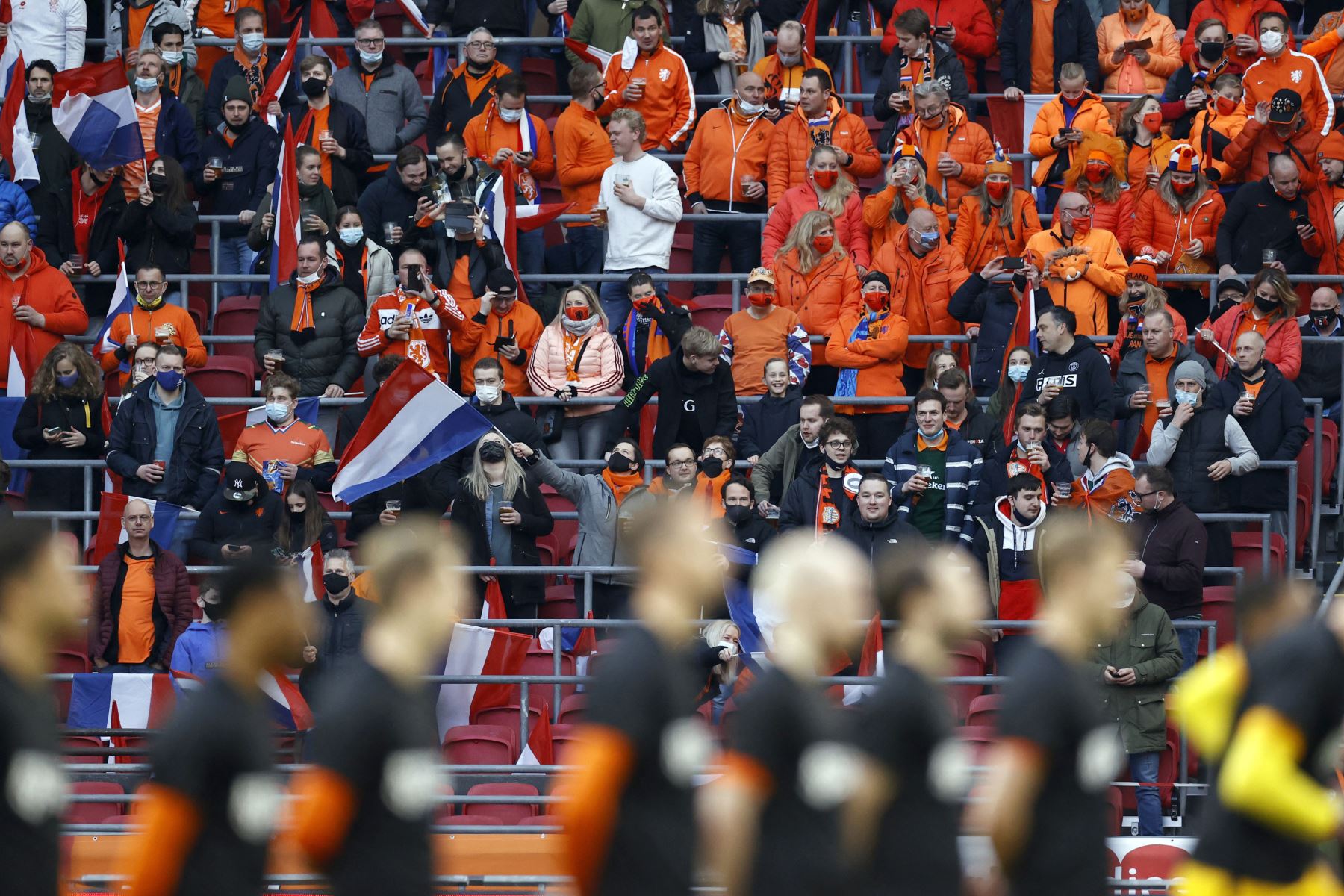 Los fanáticos holandeses, que fueron evaluados para Covid-19 más temprano en el día y dieron negativo, se reúnen en una sección del estadio durante el partido del Grupo G de clasificación para la Copa del Mundo entre Holanda y Letonia en el Johan Cruijff Arena.
Foto: AFP