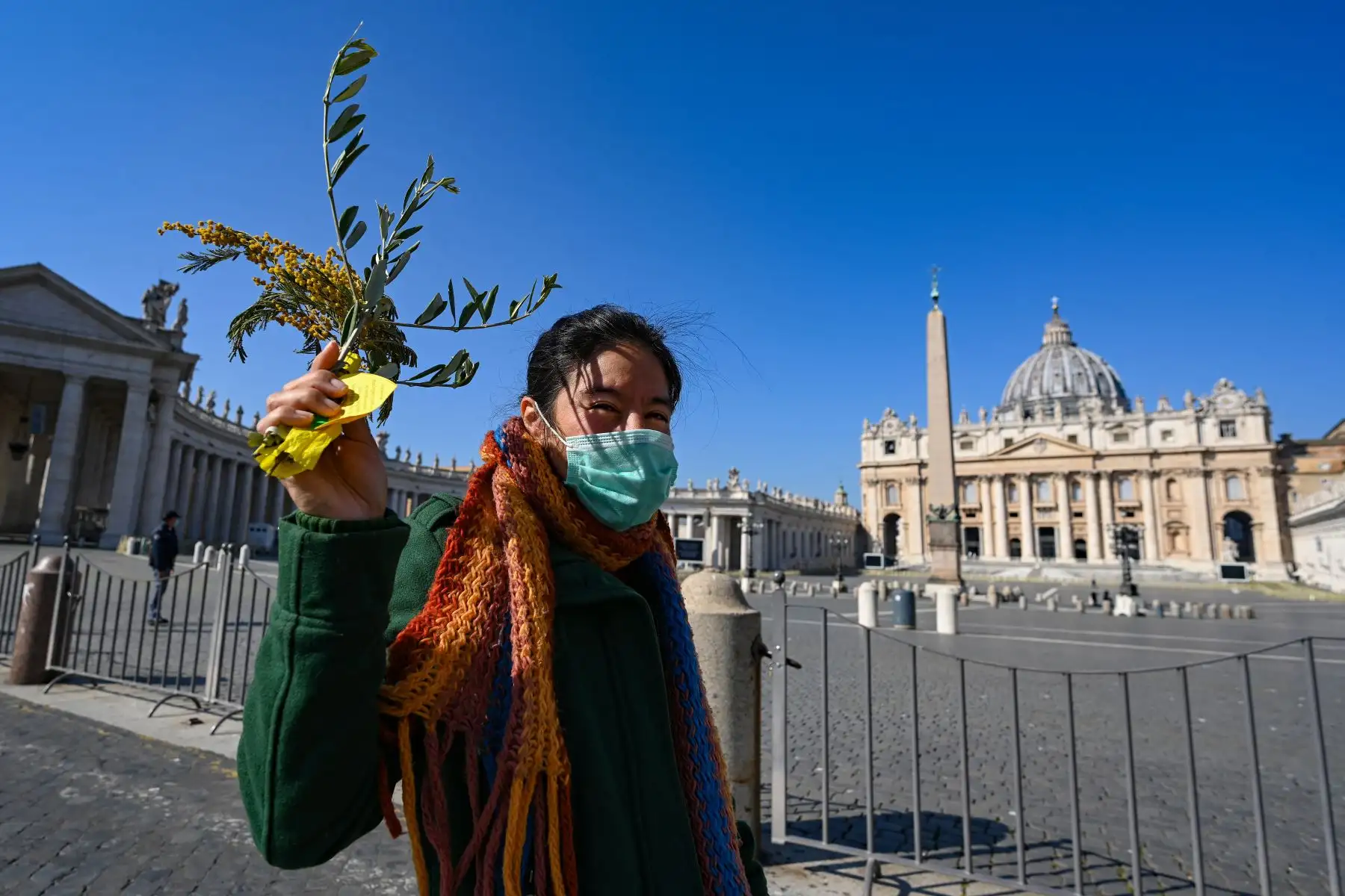 Una mujer sostiene una rama de olivo mientras el Papa celebra la misa del Domingo de Ramos, que marca el primer día de la Semana Santa, en la Basílica de San Pedro  en el Vaticano.
Vincenzo PINTO / AFP