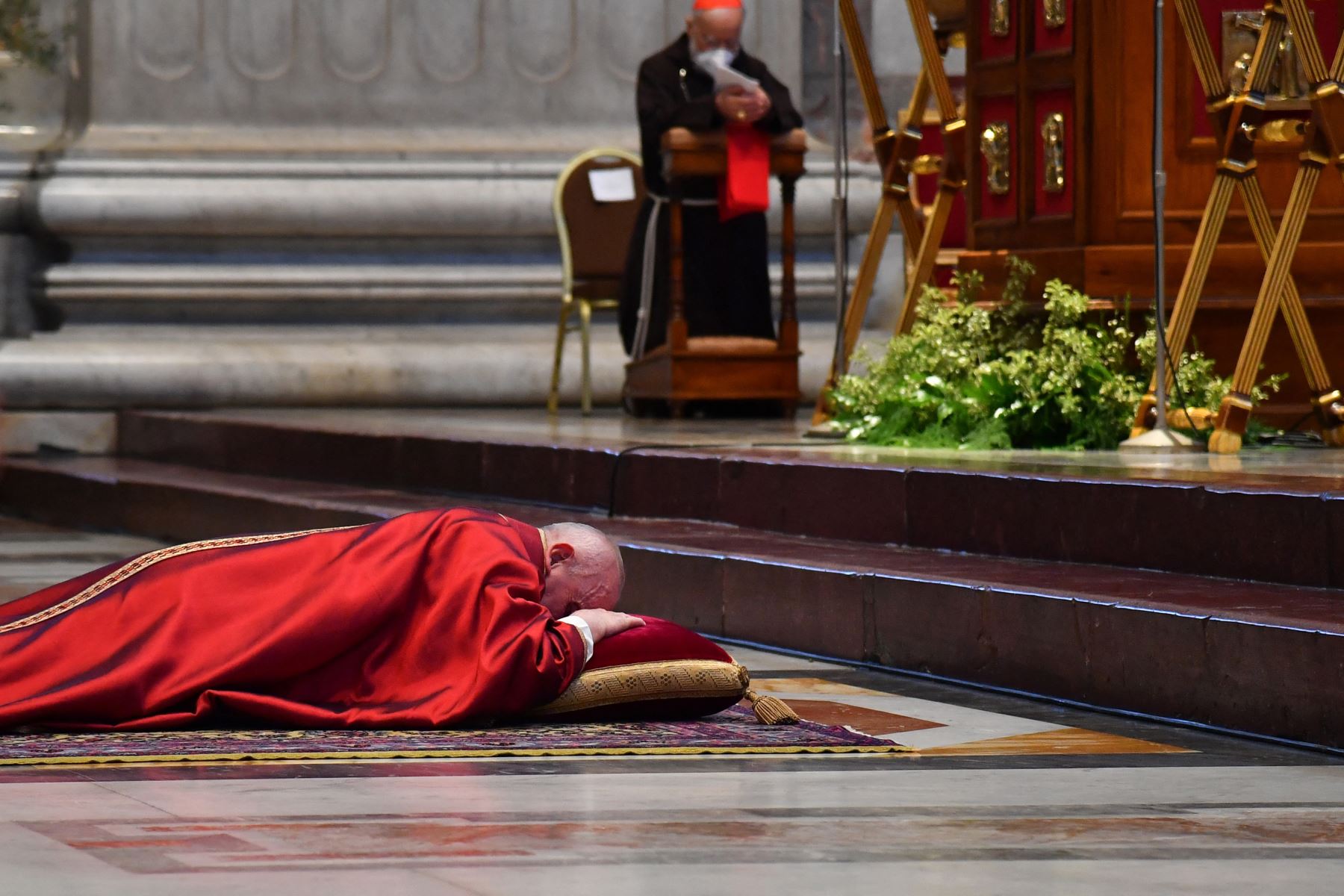 El Papa Francisco se recuesta en oración antes de celebrar la Misa del Viernes Santo en la Basílica de San Pedro en el Vaticano, durante la pandemia del coronavirus Covid-19. Foto: AFP