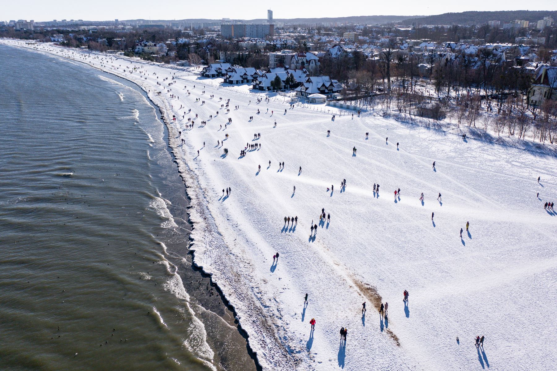 La vista aérea tomada el 14 de febrero de 2021 muestra multitudes de turistas en la playa helada de Sopot, Polonia, después de que partes de las restricciones relacionadas con la nueva pandemia de coronavirus. Foto: AFP