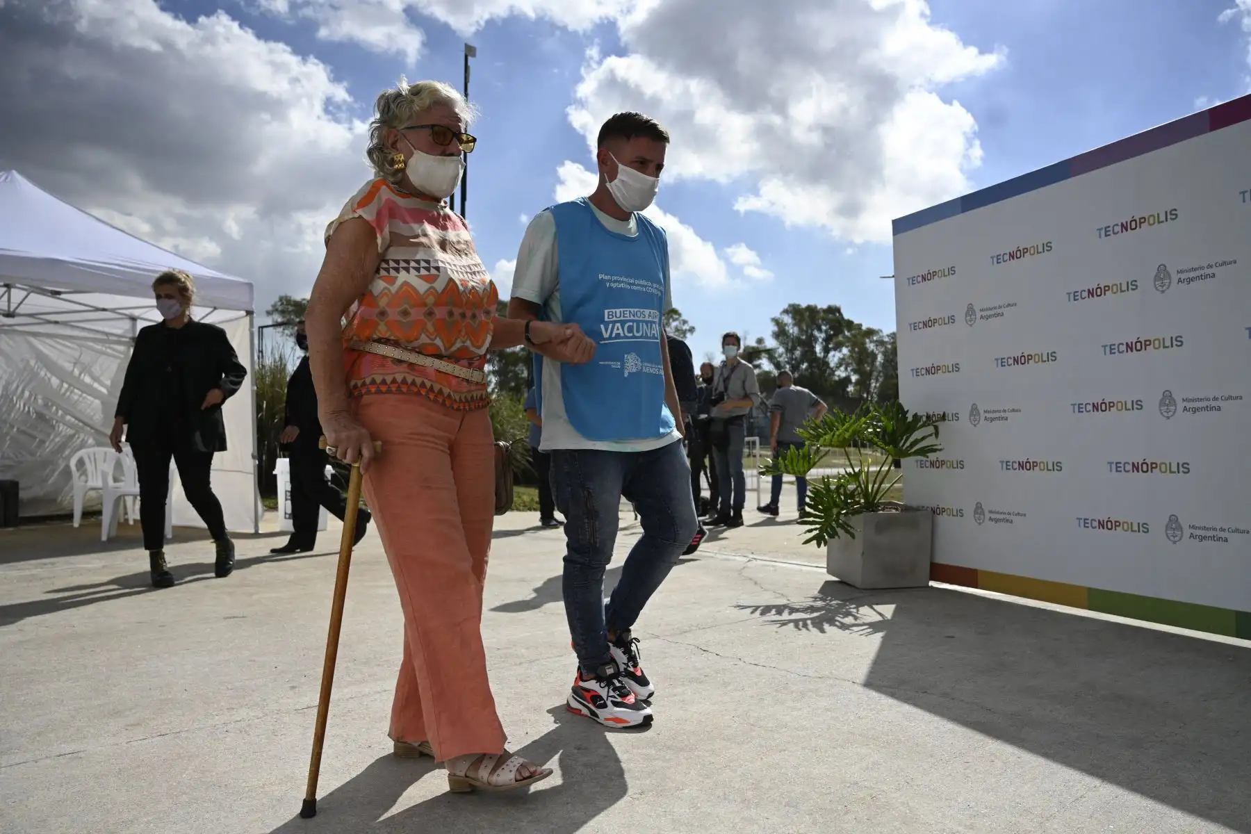 Una anciana es acompañada antes de ser inoculada con una dosis de la vacuna rusa Sputnik V contra COVID-19, en el parque Tecnopolis de Villa Martelli, provincia de Buenos Aires, Argentina, el 15 de abril de 2021. Foto: AFP