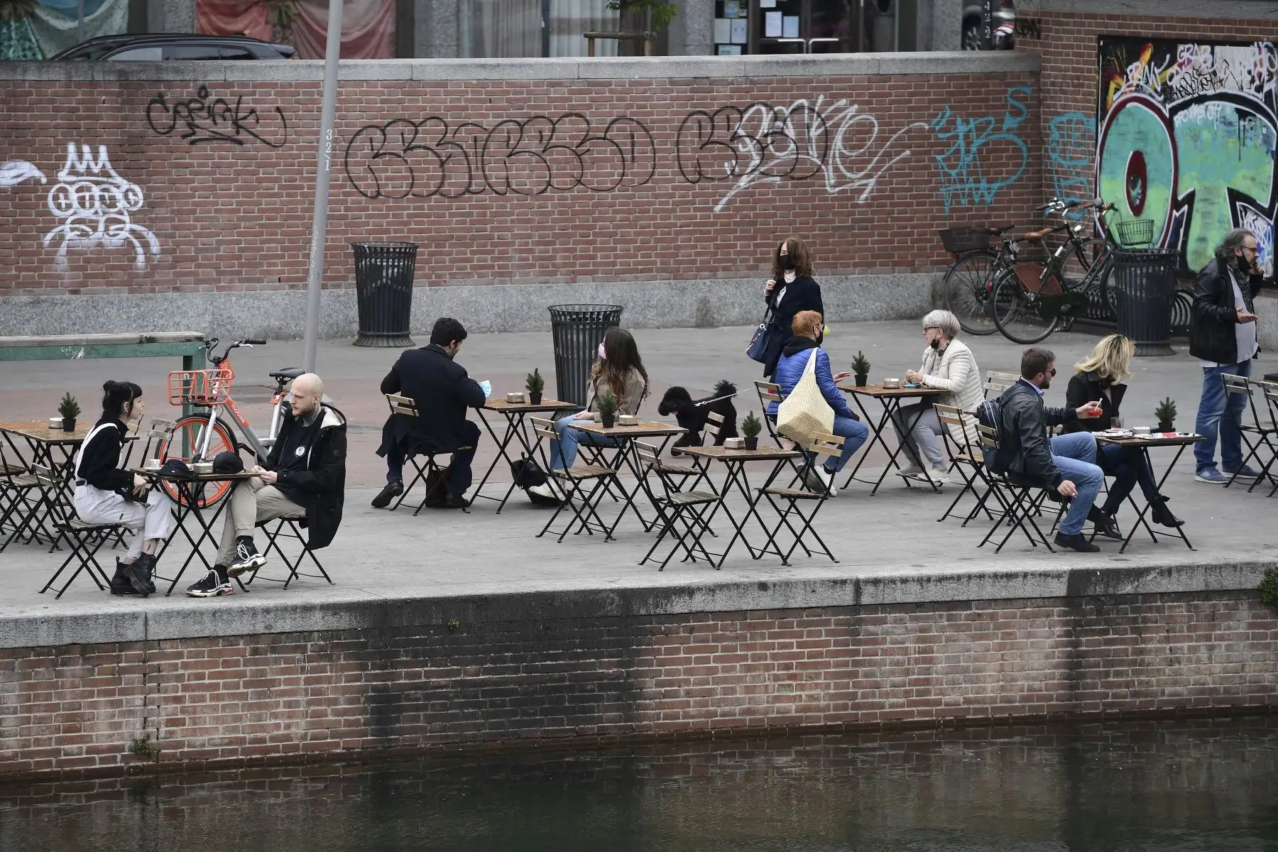 Personas disfrutan en día en la terraza de un bar en el barrio de Naviglio, el 26 de abril de 2021, en Milán. Foto: AFP