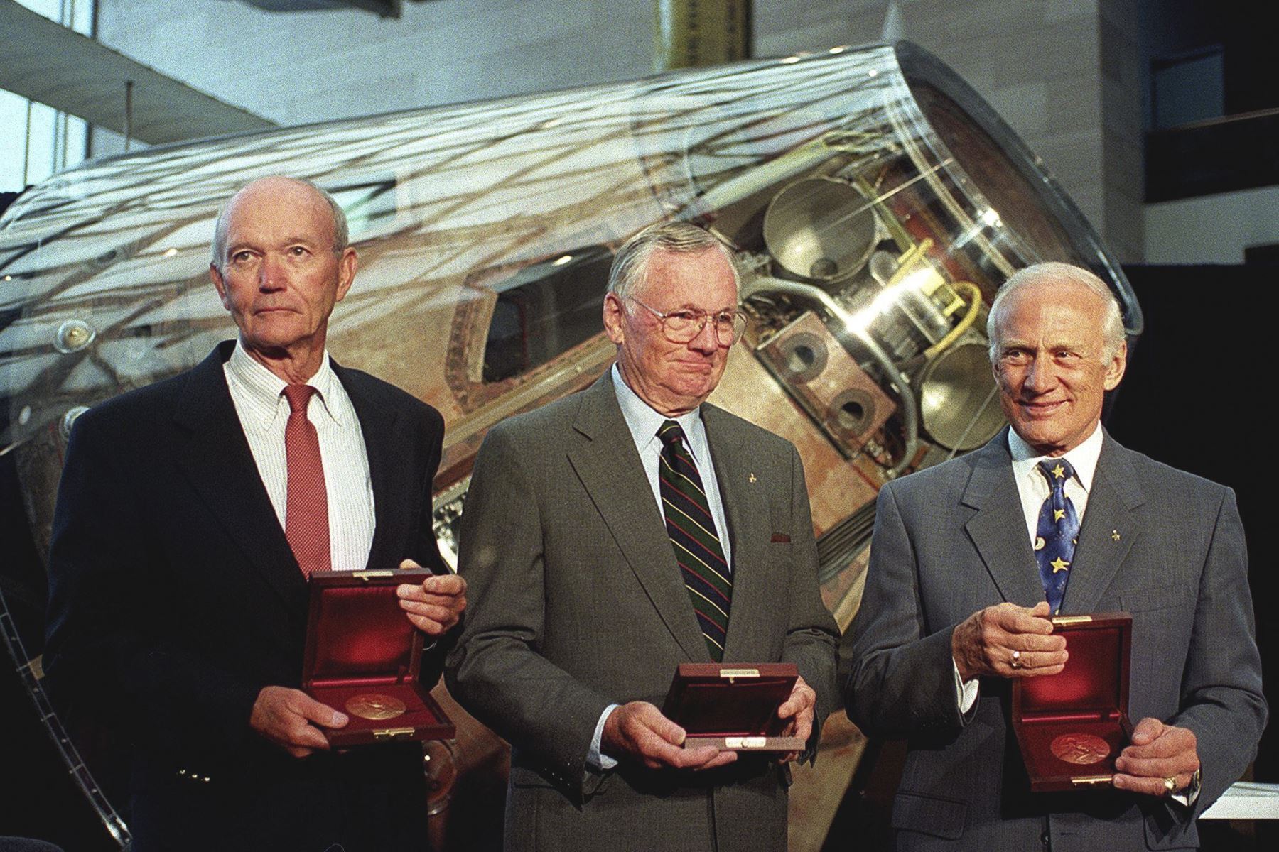 La tripulación del Apollo 11 Michael Collins (L), Neil Armstrong (C) y Buzz Aldrin se paran frente al módulo de comando del Apollo Columbia después de que el Vicepresidente de los Estados Unidos Al Gore les otorgara la medalla Samuel P. Langley el 20 de julio de 1999 en el National Air y el Museo del Espacio en Washington, DC. Foto: AFP