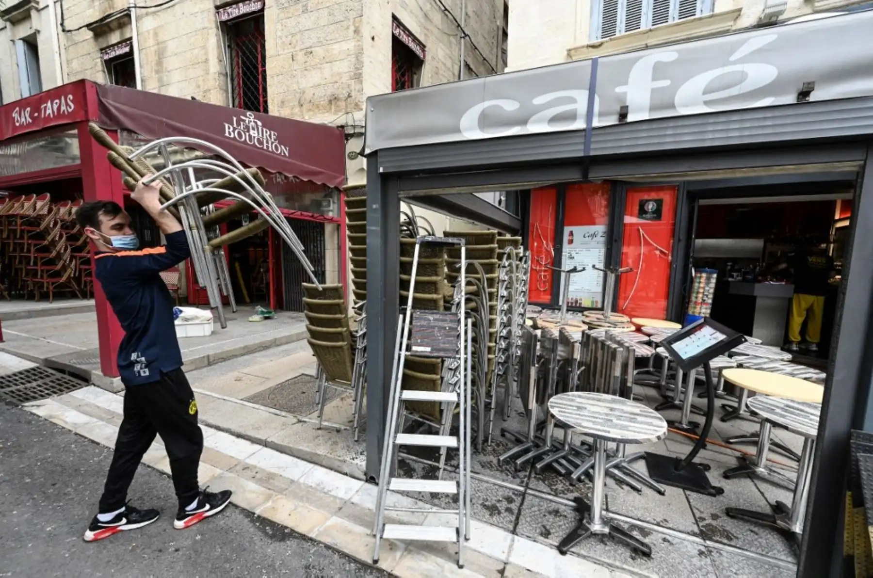 Un hombre instala la terraza de un restaurante en la ciudad de Montpellier, en el sur de Francia, el 17 de mayo de 2021. Foto: AFP