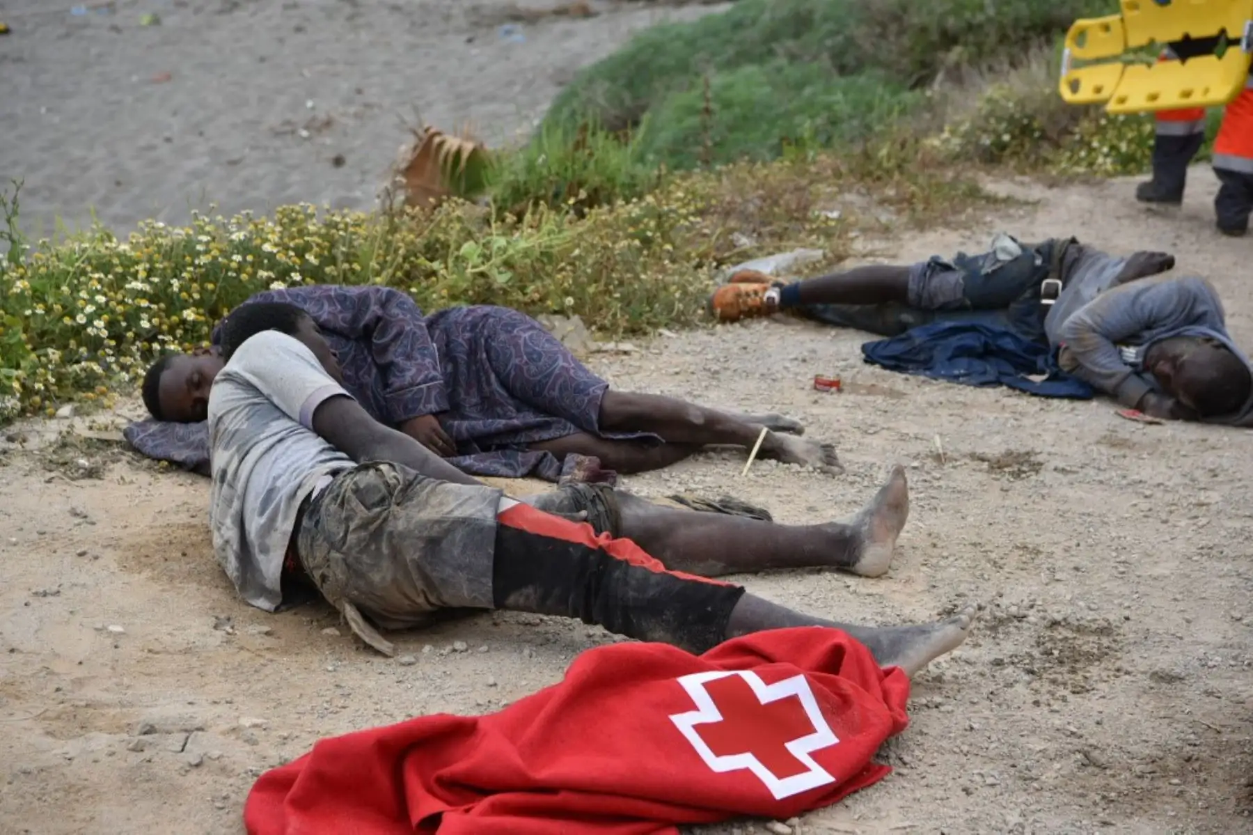 Los migrantes descansan tras nadar hacia la orilla del enclave español de Ceuta el 18 de mayo de 2021. España ha regresado a Marruecos casi la mitad de los 6.000 migrantes que entraron en su enclave de Ceuta, mientras cientos más intentaban entrar en su otro territorio norteafricano. Foto: AFP