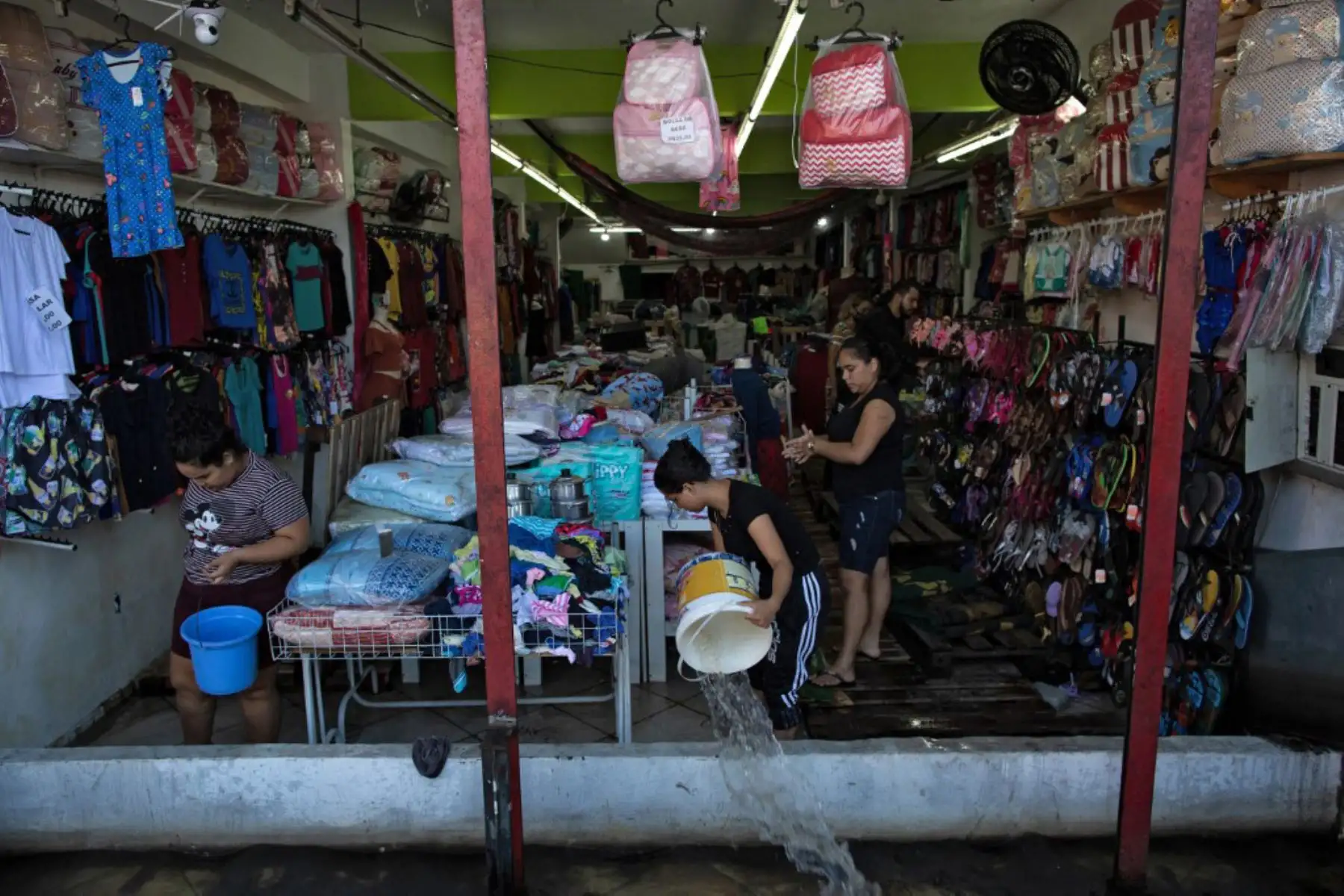 Trabajadores sacan agua de un almacén inundado en el centro de la ciudad de Manaos, capital del estado brasileño de Amazonas tras la crecida del Río Negro, afluente del río Amazonas que alcanzó los 29,98 metros, haciendo un nuevo nivel récord de la temporada de inundaciones.  Manaos y otras 35 ciudades han decretado el estado de emergencia por el desbordamiento del río.

Foto: AFP