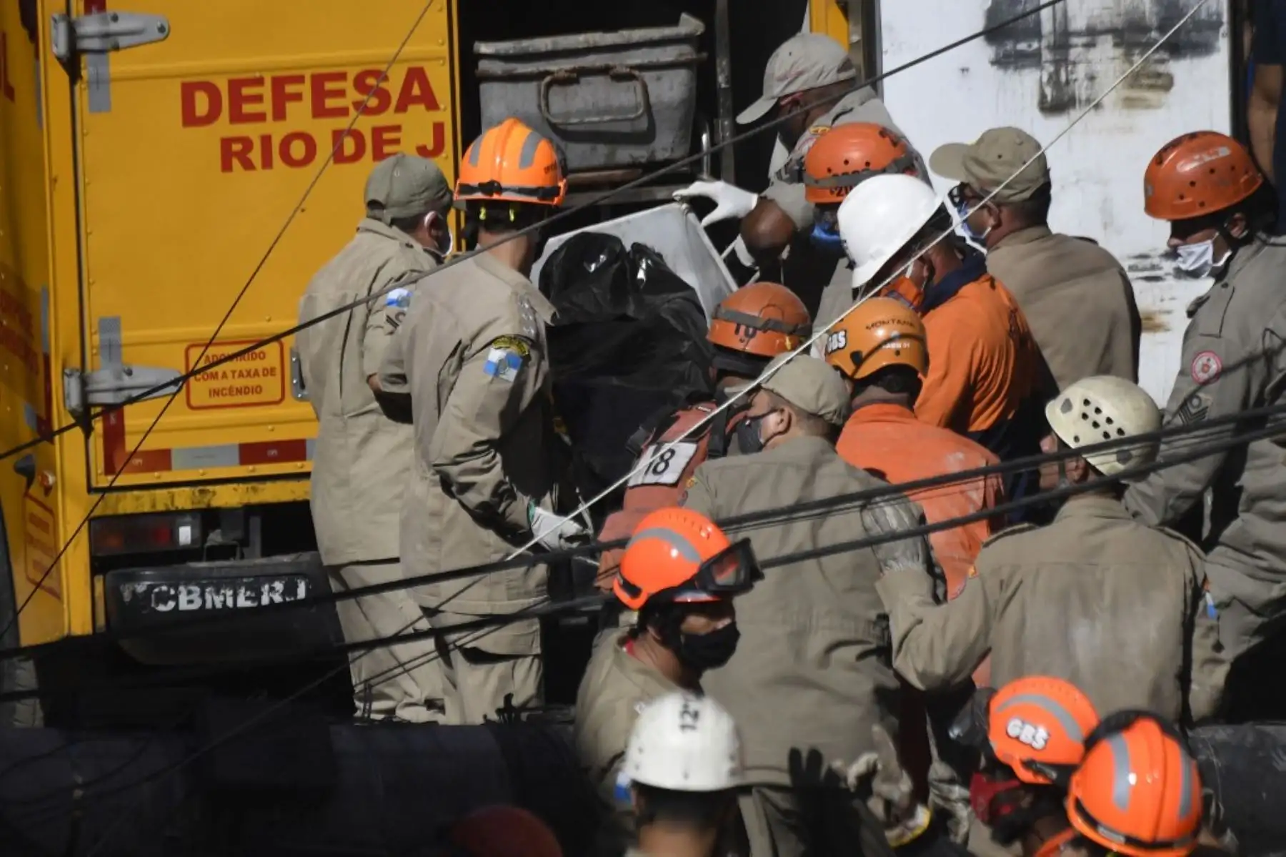 Bomberos y equipos de rescate mueven el cuerpo de una víctima del derrumbe de un edificio temprano en la mañana en la favela Rio das Pedras en Río de Janeiro, Brasil, el 3 de junio de 2021. Foto: AFP