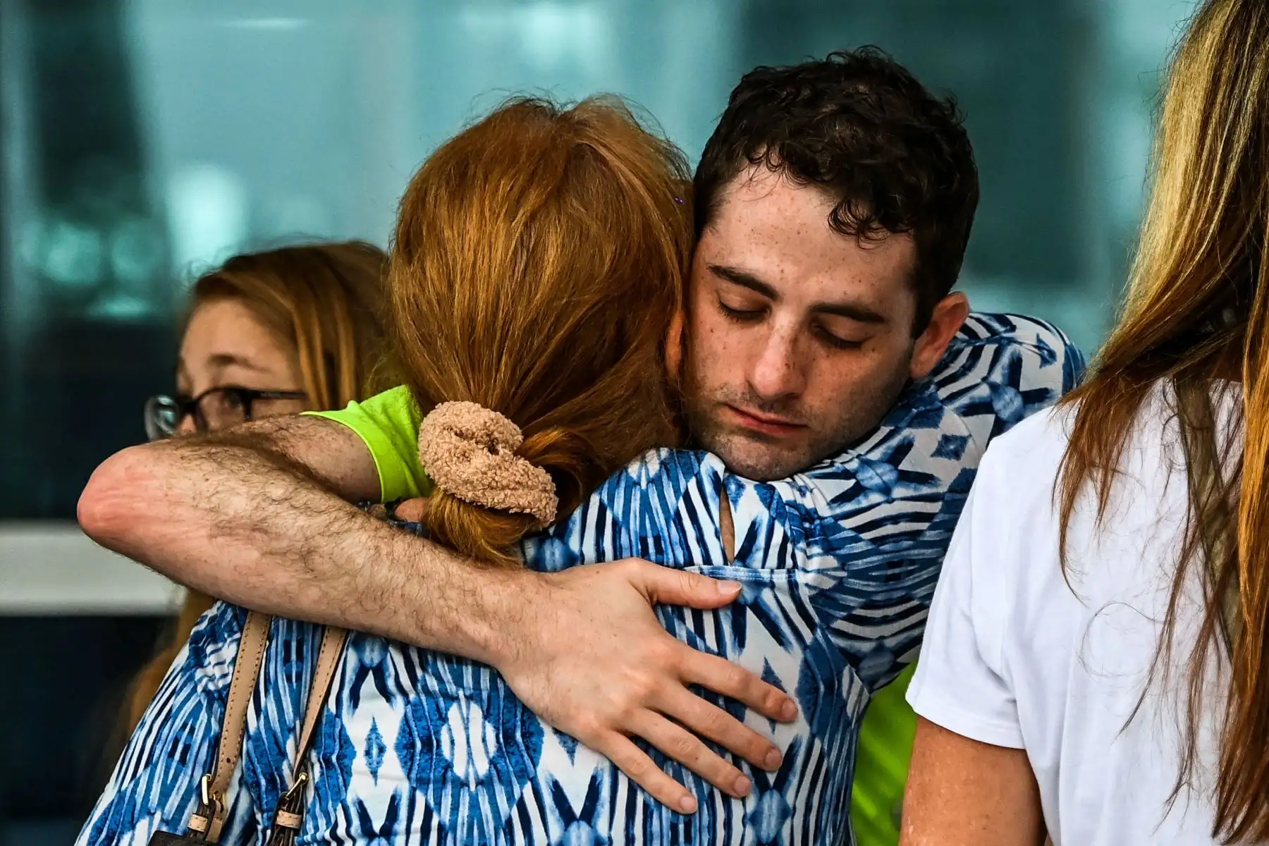 Los familiares y residentes de Champlain Towers South se saludan frente al Town of Surfside Community Center en Surfside, al norte de Miami Beach. Foto: AFP