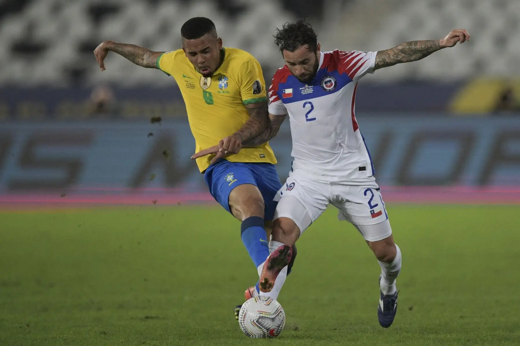 El brasileño Gabriel Jesus y el chileno Eugenio Mena compiten por el balón durante el partido de cuartos de final de la Copa América, en el estadio Nilton Santos de Río de Janeiro, Brasil. Foto: AFP