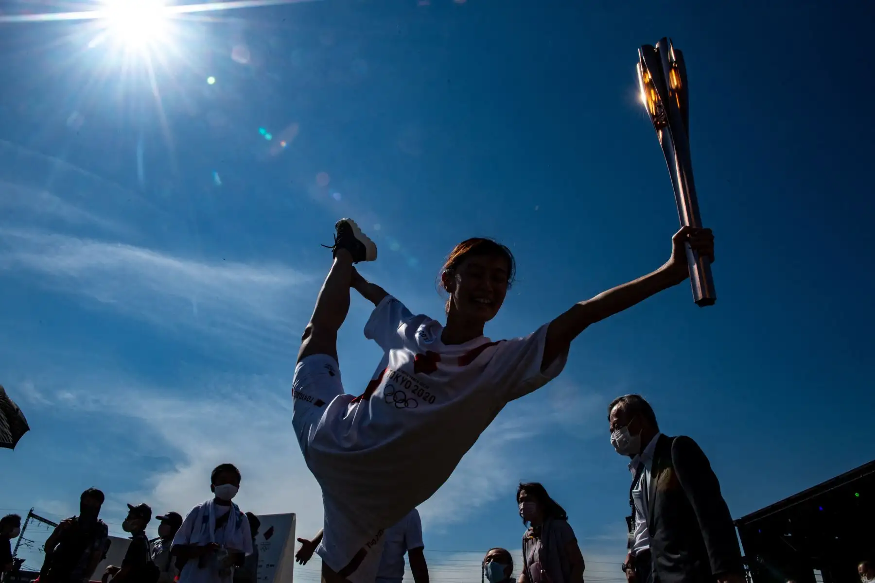 La portadora de la antorcha Yukari Miwa sostiene su antorcha olímpica frente a los medios de comunicación después del beso de la antorcha durante la ceremonia de encendido en el Parque Central de Shinagawa en Tokio. Foto: AFP