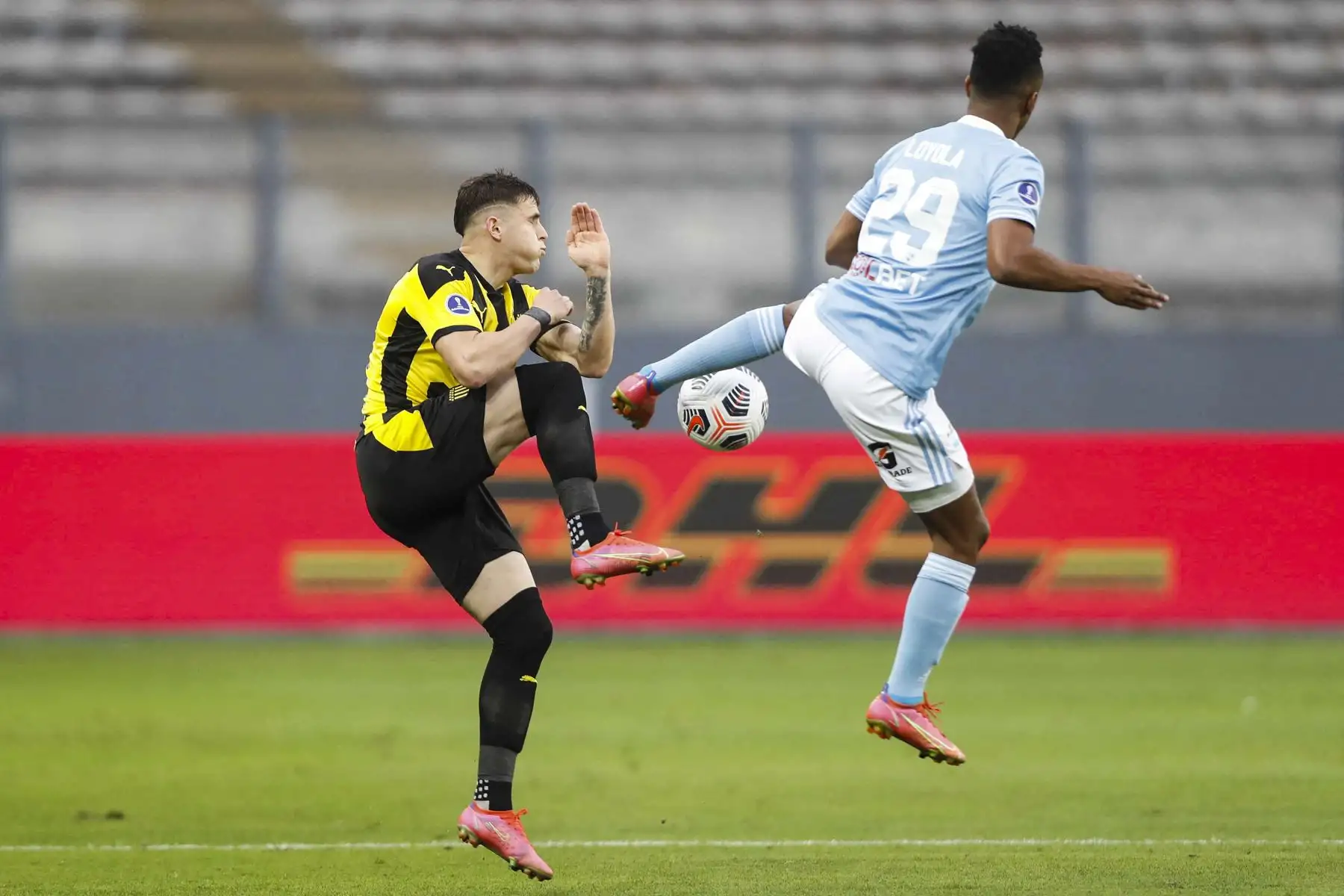El uruguayo Peñarol Giovanni González y el peruano Sporting Cristal Nilson Loyola disputan el balón durante partido por los cuartos de final de la Copa Sudamericana, en el Estadio Nacional. Foto: AFP