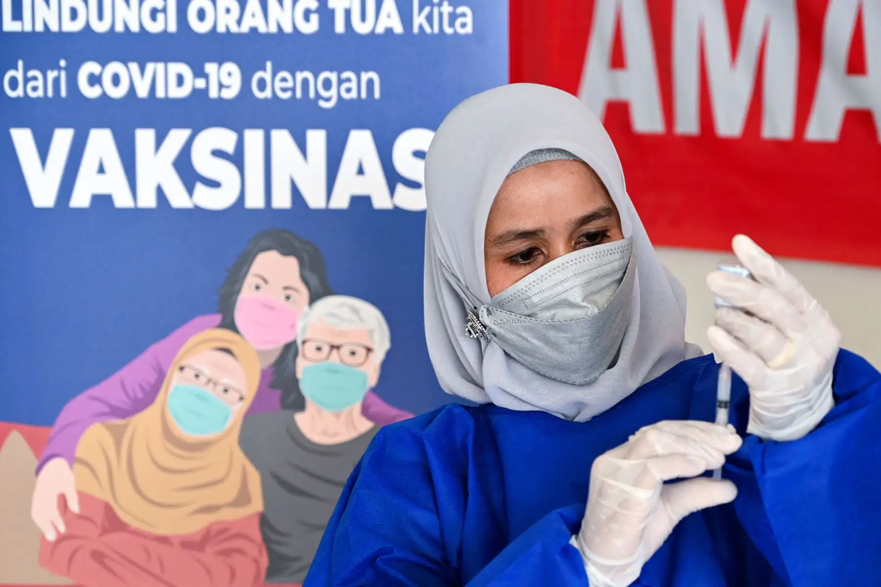 Un trabajador de la salud se prepara para administrar una dosis de la vacuna Moderna Covid-19, donada a Indonesia por los EE. UU., Durante una campaña de vacunación de refuerzo en Barona Jaya, en las afueras de Banda Aceh.
Foto: AFP