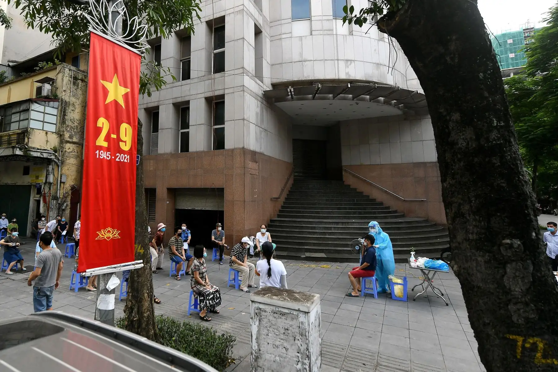 Un trabajador de la salud que usa equipo de protección personal  recolecta muestras de hisopos de residentes para la prueba de covid-19 a lo largo de una calle en Hanoi, en medio de que el gobierno impuso un bloqueo de dos semanas para detener la propagación del coronavirus. 
Foto: AFP