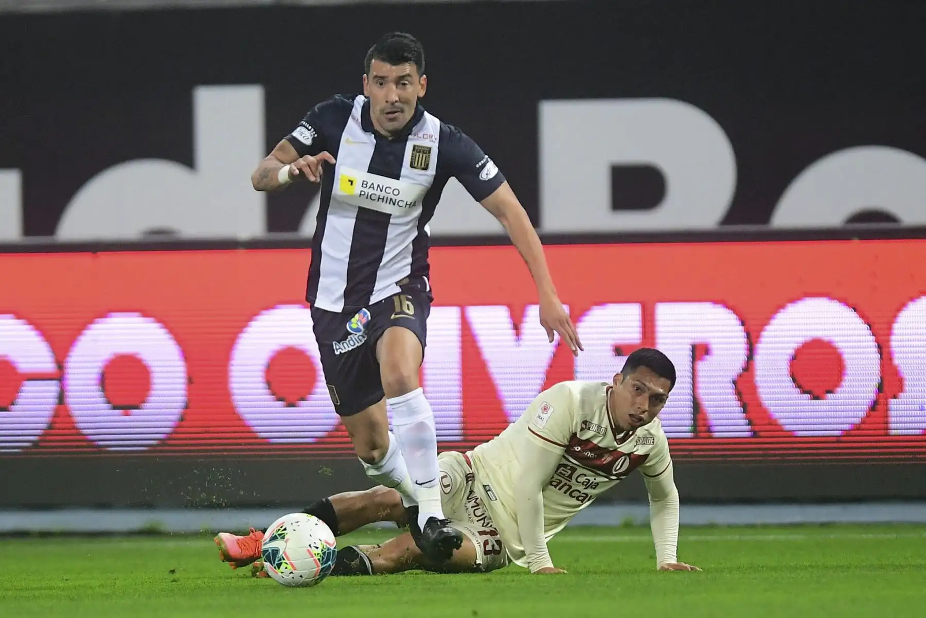 E. Benítez de Alianza Lima gana el balón a G. Barreto de Universitario de Deportes en el clásico peruano por un partido de la fecha 7 de la Fase 2 de la Liga 1 desde el Estadio Nacional. Foto: La Liga