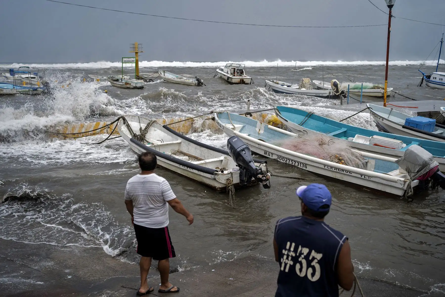 Los pescadores se preparan para sacar los botes del muelle mientras las fuertes olas llegan a la costa debido al huracán Grace, que alcanzó la categoría 2, en Boca del Río, Veracruz, México. Foto: AFP