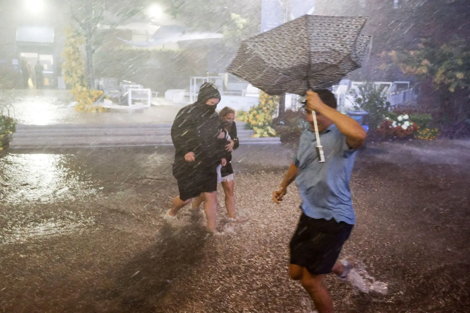 Personas caminan a través de fuertes lluvias y pasillos inundados en el Centro Nacional de Tenis Billie Jean King cuando los restos del huracán Ida azotaron la zona de Flushing Meadows, Nueva York, Estados Unidos. Foto: EFE