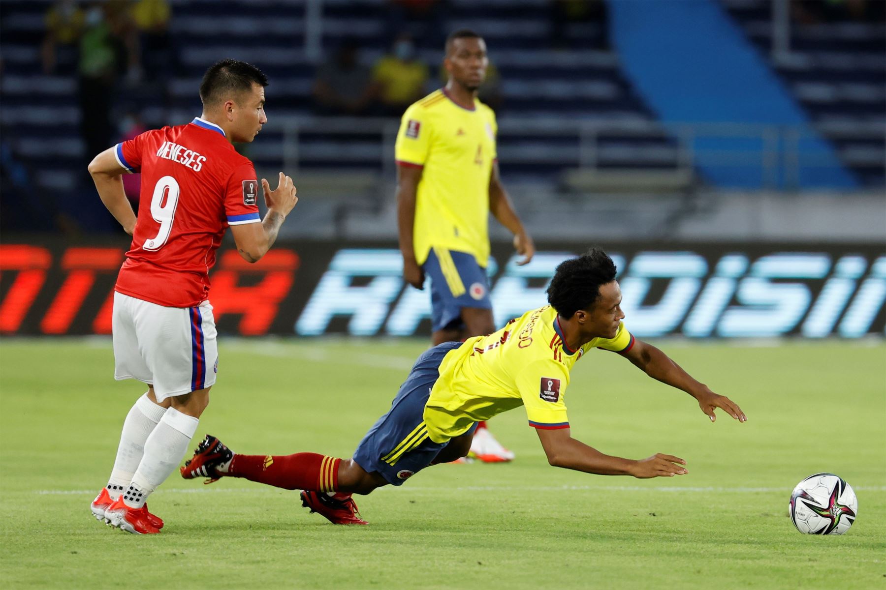 Juan Cuadrado de Colombia disputa  el balón con Jean Meneses de Chile durante un partido por las eliminatorias sudamericanas para el Mundial de Catar 2022, en el estadio Metropolitano en Barranquilla.
Foto: EFE