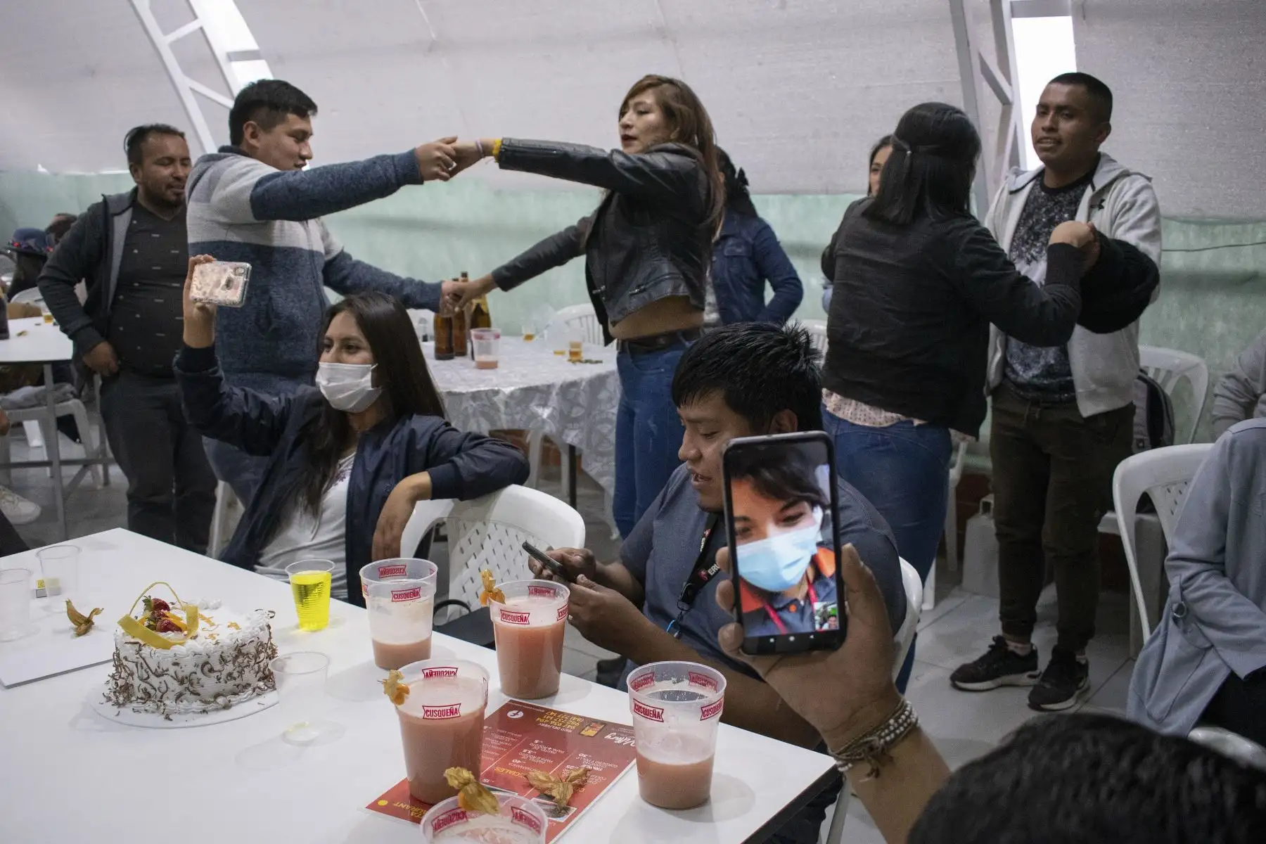 Un asistente realiza una videollamada para transmitir un concierto virtual semi-presencial en el restaurante Killary en Cusco. Foto: Sharon Castellanos, con el apoyo del Fondo de emergencia COVID-19 de The National Geographic Society