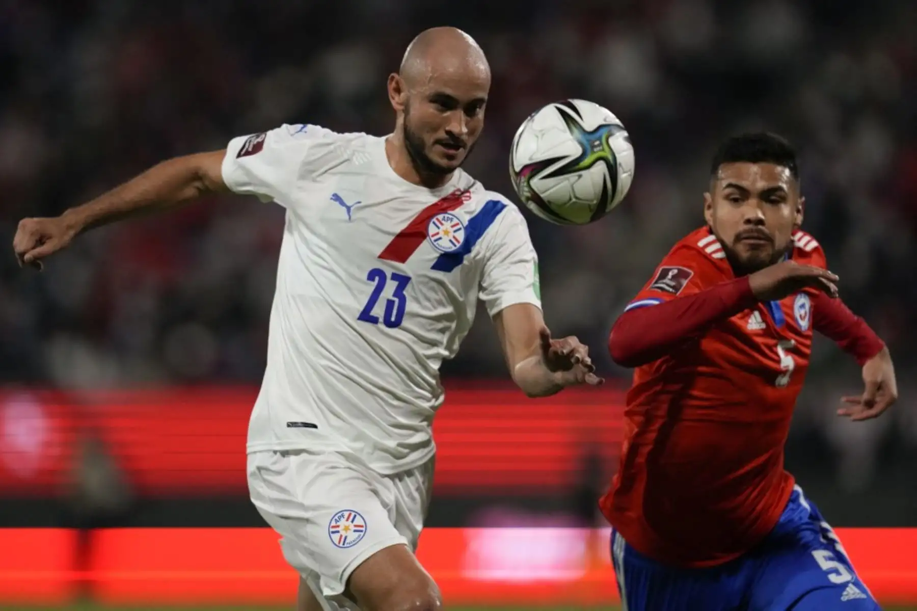 Carlos González (izquierda) de Paraguay y Paulo Díaz (derecha) de Chile compiten por el balón durante el partido de fútbol de clasificación sudamericano para la Copa Mundial de la FIFA Qatar 2022 en el estadio San Carlos de Apoquindo en Santiago, el 10 de octubre de 2021. Foto: AFP