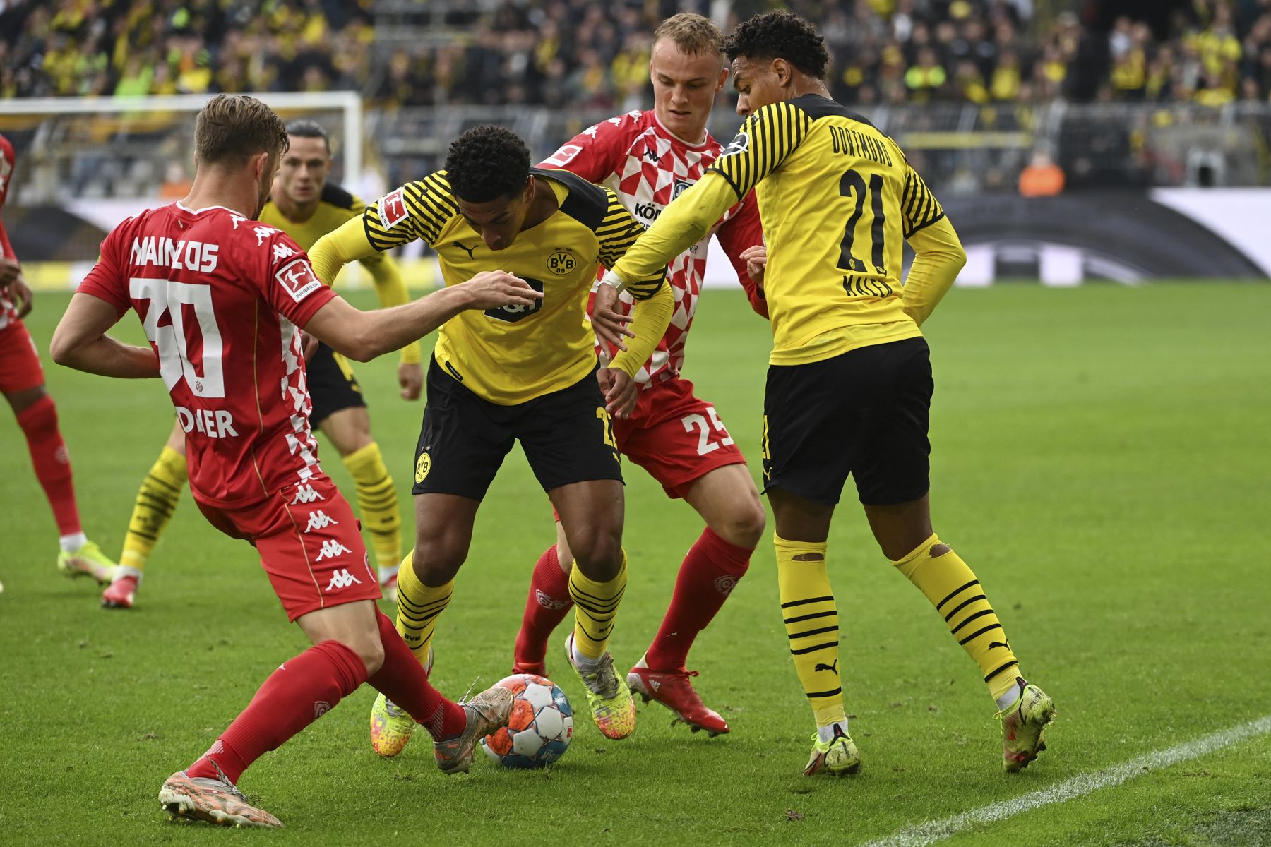 El defensor suizo de Mainz Silvan Widmer compite por  el balón con centrocampista inglés del Dortmund, Jude Bellingham, durante el partido de la Bundesliga. Foto: AFP