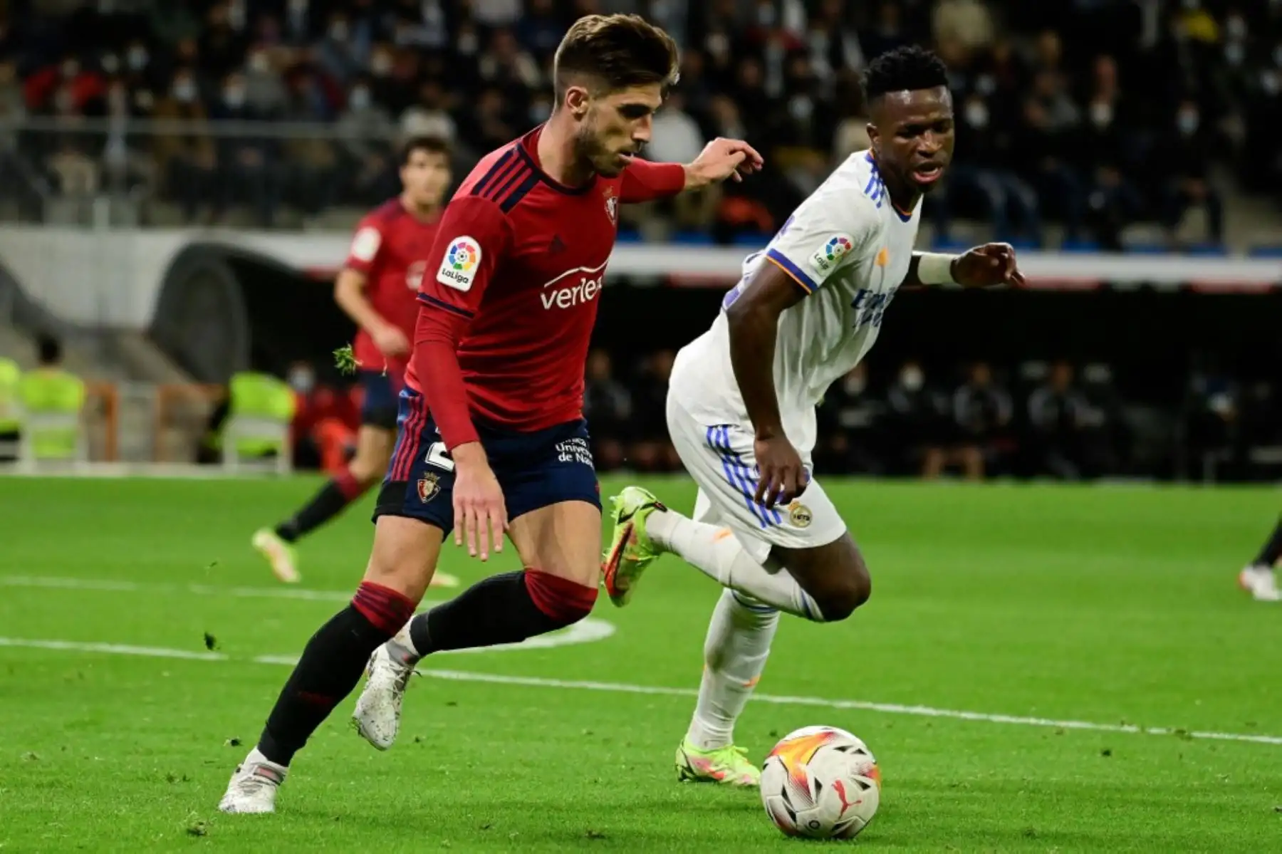 El defensor español de Osasuna, Nacho Vidal, lucha por el balón con el delantero brasileño del Real Madrid Vinicius Junior durante el partido de fútbol de la Liga española entre el Real Madrid CF y el CA Osasuna en el estadio Santiago Bernabeu de Madrid el 27 de octubre de 2021. Foto: AFP