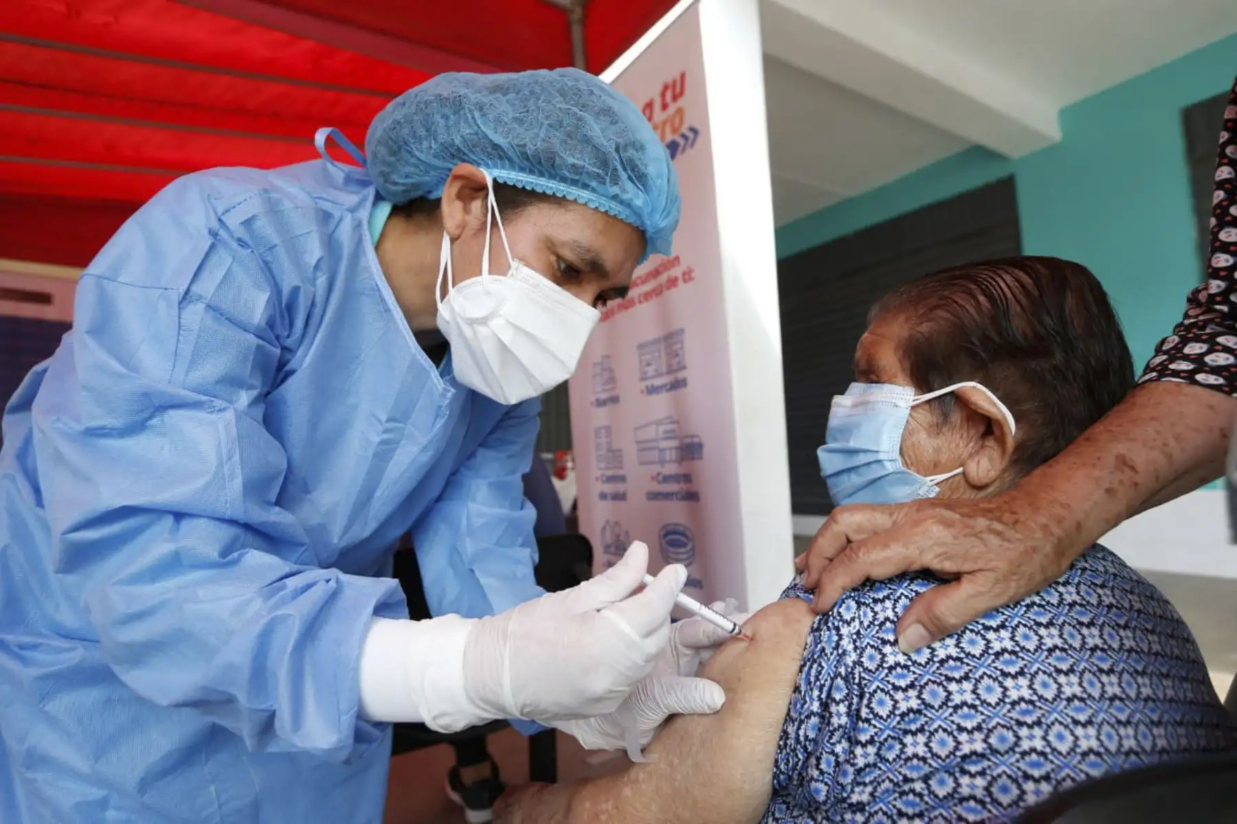 El ministro de Salud, Hernando Cevallos, supervisa la vacunación de adultos mayores que acuden al Banco de la Nación de Villa El Salvador a recibir el bono. Foto: Minsa