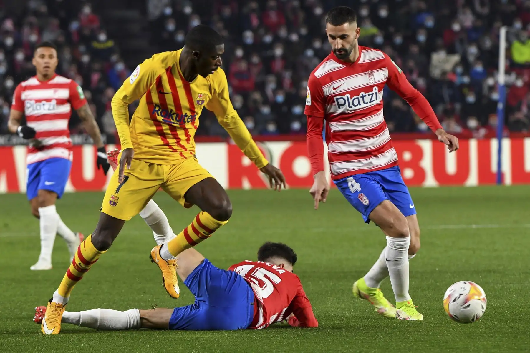 El delantero francés del Barcelona, Ousmane Dembélé, pelea un balón con el defensa del Granada, Carlos Neva, durante el partido de LaLiga, en el Nuevo Estadio de Los Cármenes. Foto: EFE