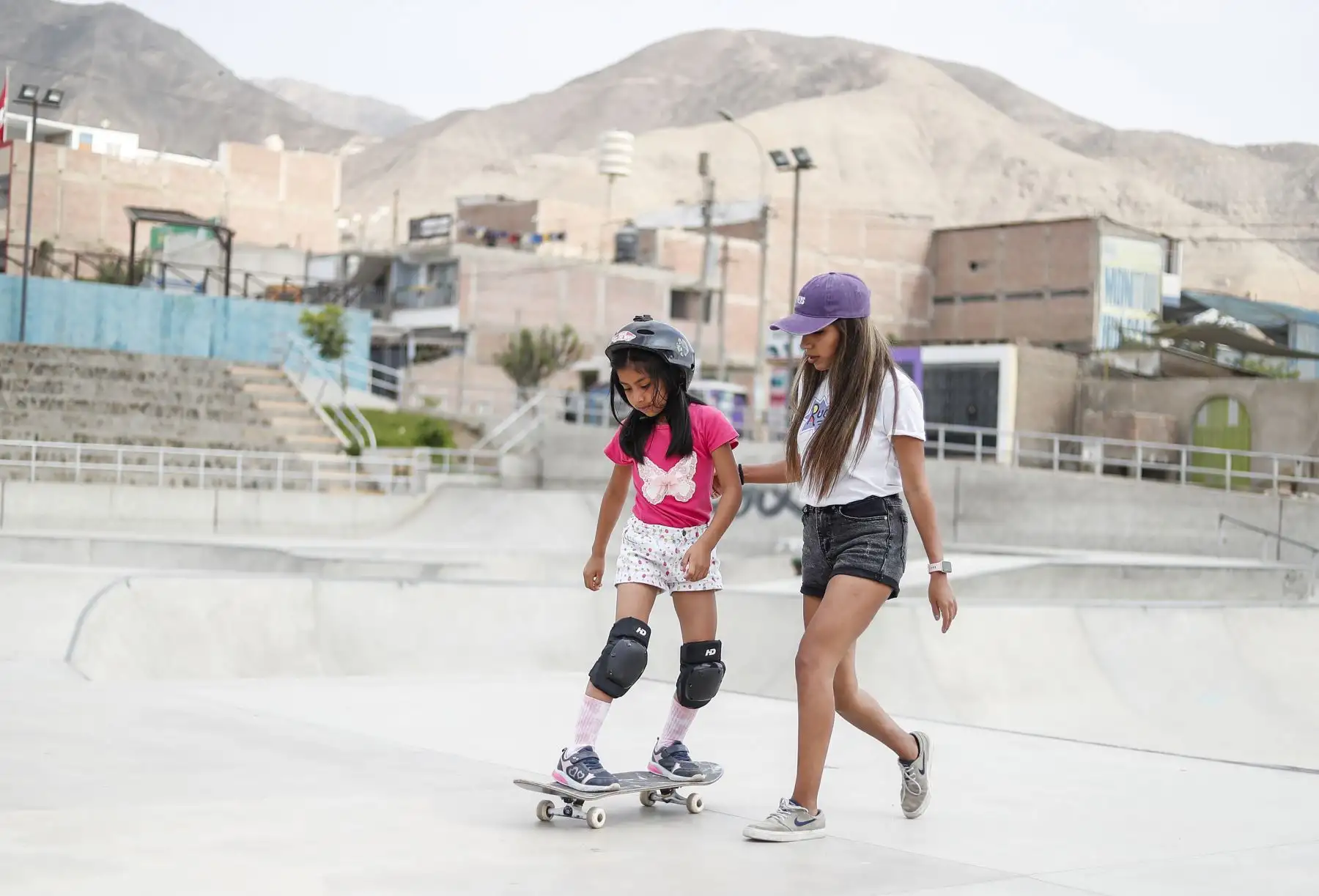 Dayanna Espino le enseña a la pequeña Valentina deslizarse sobre el skate. Junto a sus compañeras acostumbra organizar encuentros y competencias para todo amante de este deporte olímpico. Foto: ANDINA/Renato Pajuelo