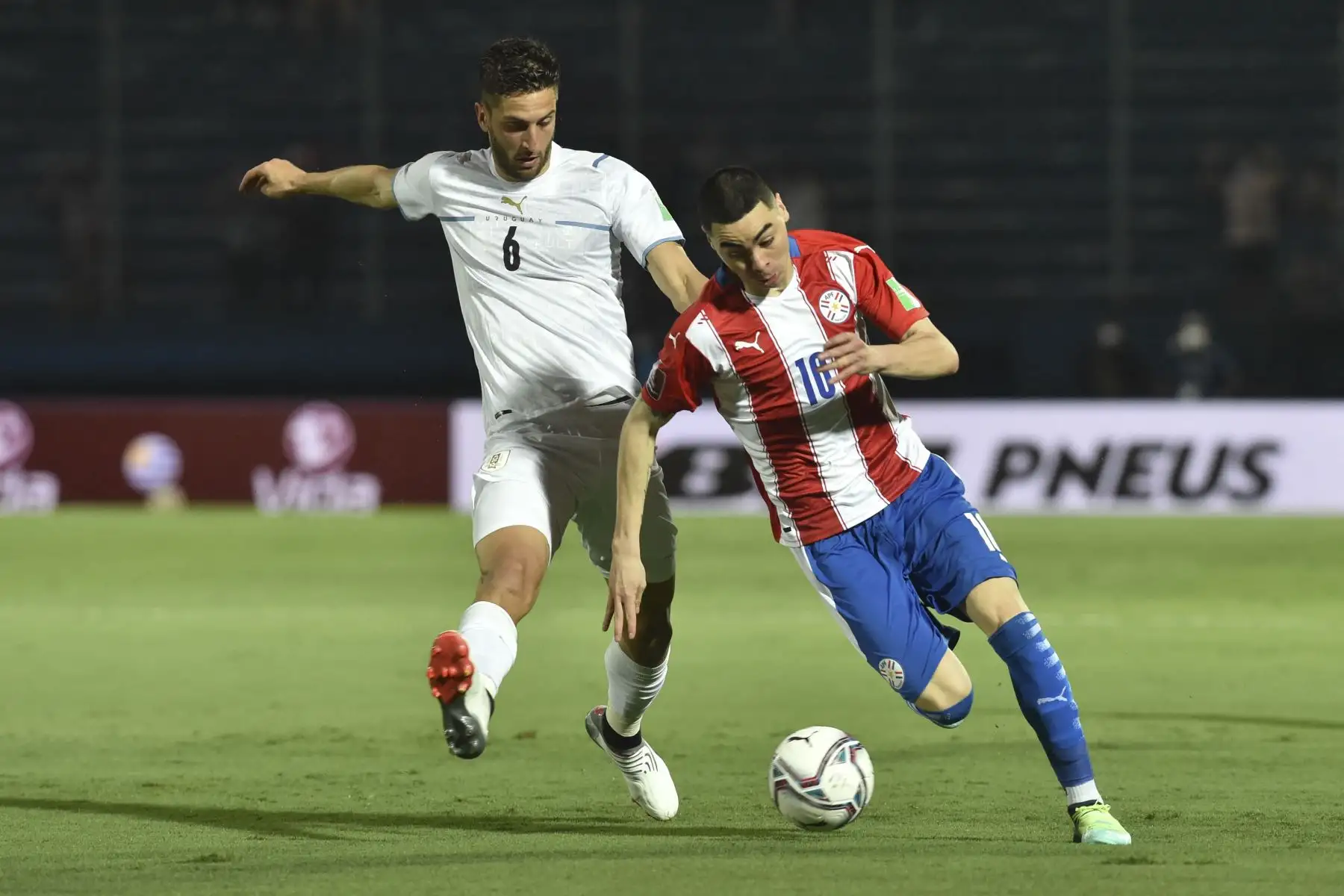 Rodrigo Bentancur (L) de Uruguay y Miguel Almiron (R) de Paraguay compiten por el balón durante un partido de clasificación para la Copa Mundial de la FIFA Qatar 2022 en el Estadio General Pablo Rojas en Asunción. Foto: AFP
