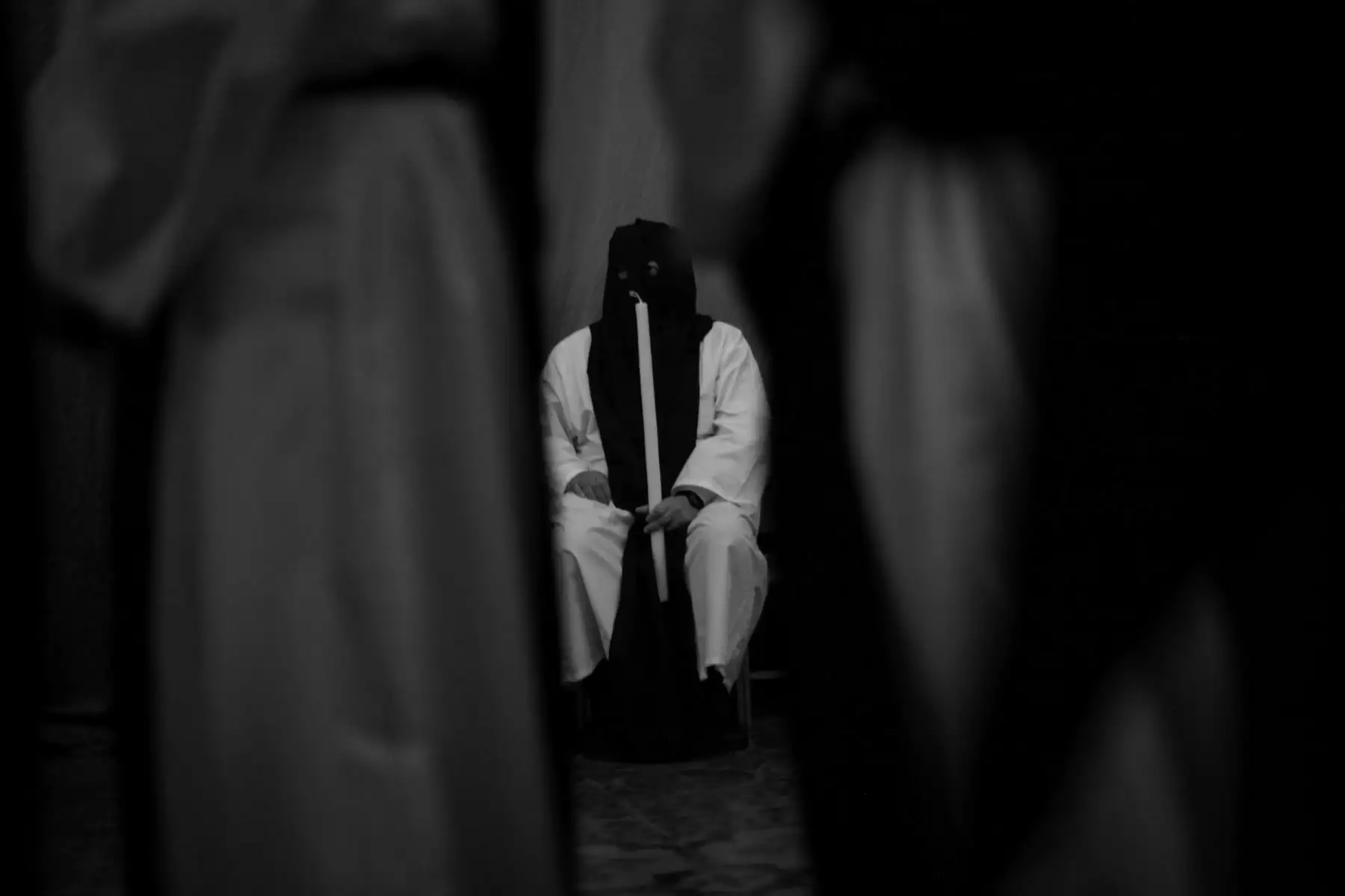 La ceremonia tiene una atmósfera solemne debido a la iluminación con velas, los cantos en latín y las vestimentas tradicionales. Muestra fotográfica “Siglos de fe, la Cofradía de la Soledad y la Semana Santa de Lima” de Pancho Rodríguez
