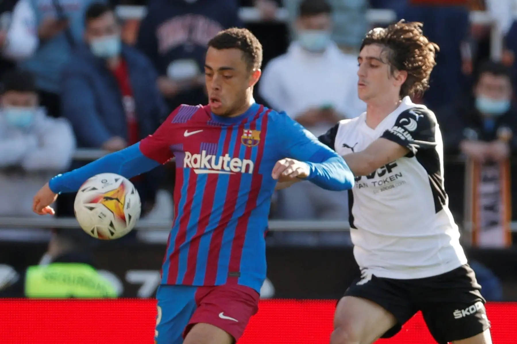 El centrocampista del Valencia, Bryan Gil (d) pelea un balón con el defensa estadounidense del FC Barcelona, Sergiño Dest, durante el partido de LaLiga que se disputa este domingo en el estadio de Mestalla. EFE/ Manuel Bruque