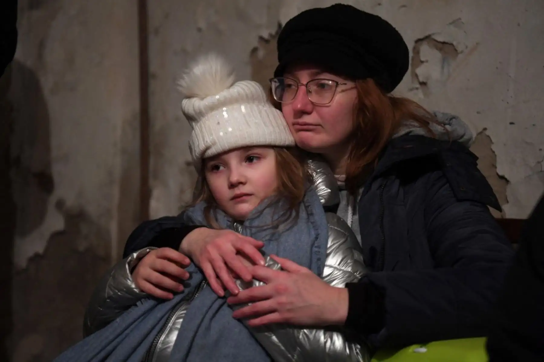 Helga Tarasova abraza a su hija Kira Shapovalova mientras esperan en un refugio subterráneo durante una alerta de bombardeo en la capital ucraniana de Kiev el 26 de febrero de 2022. Foto: AFP