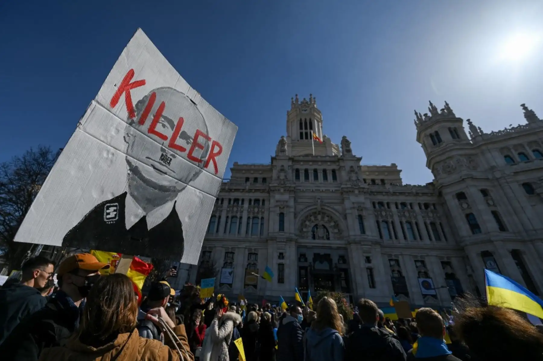 Un manifestante sostiene un cartel que representa al presidente ruso Vladimir Putin y dice "Asesino" frente al Palacio de Cibeles durante una protesta contra la invasión rusa de Ucrania en la Plaza de Cibeles en Madrid el 27 de febrero de 2022. Foto: AFP