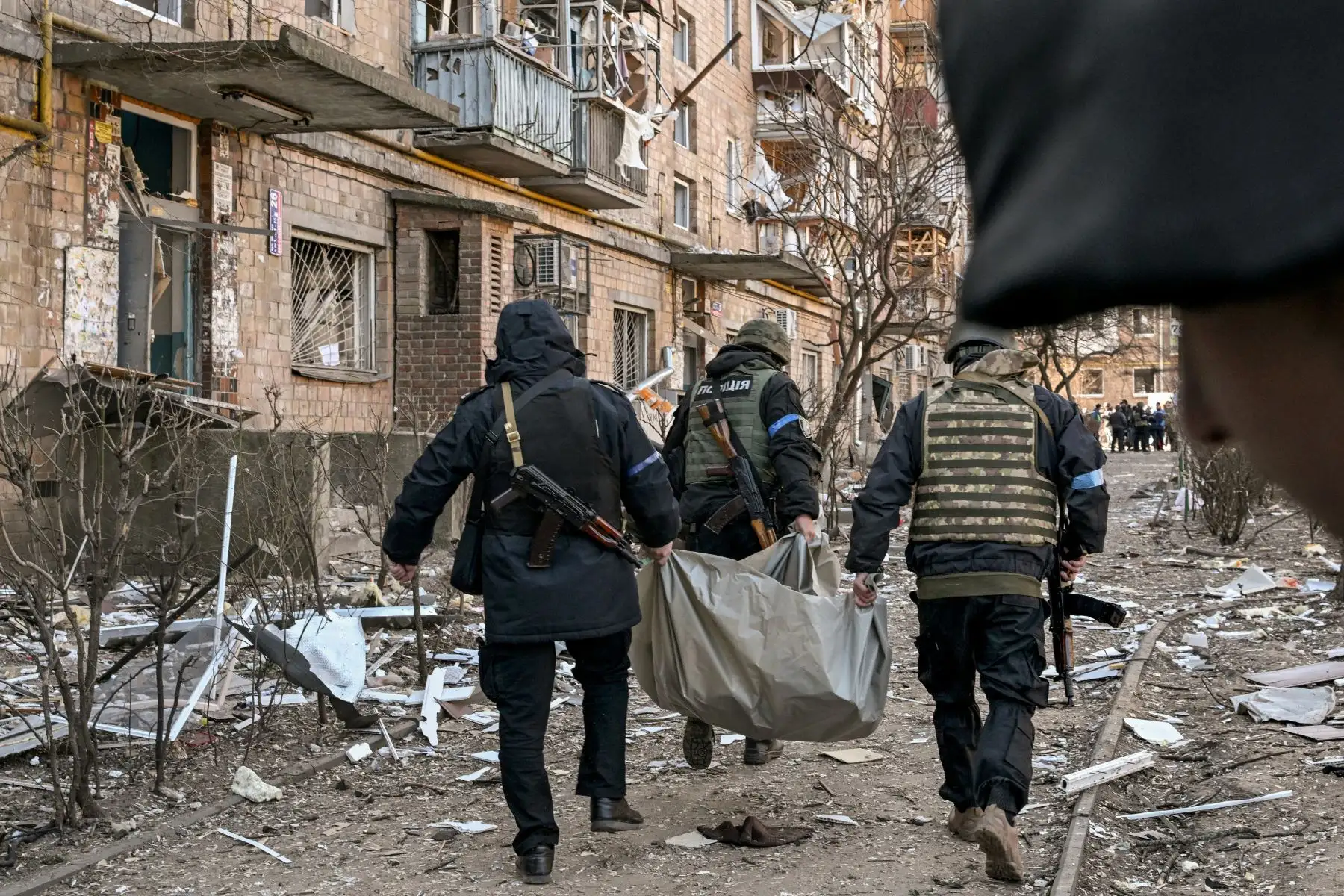 Policías ucranianos sacan un cuerpo de un edificio residencial de cinco pisos que se derrumbó parcialmente después de un bombardeo en Kiev. Foto: AFP