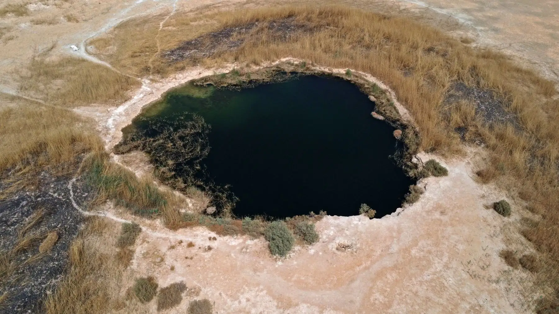 Una vista aérea muestra un estanque que queda en el lago seco Sawa en la provincia de al-Muthanna, en el sur de Irak, el 19 de abril de 2022.
Foto: ANDINA/AFP