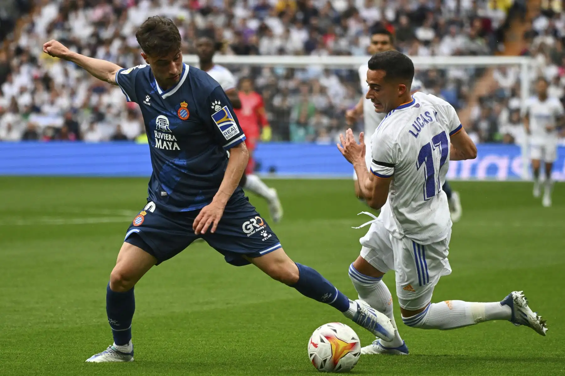 El delantero español del Espanyol, Javi Puado (L), lucha por el balón con el delantero español del Real Madrid, Lucas Vázquez, durante el partido de fútbol de la Liga española entre el Real Madrid CF y el RCD Espanyol en el estadio Santiago Bernabeu. Foto: AFP
