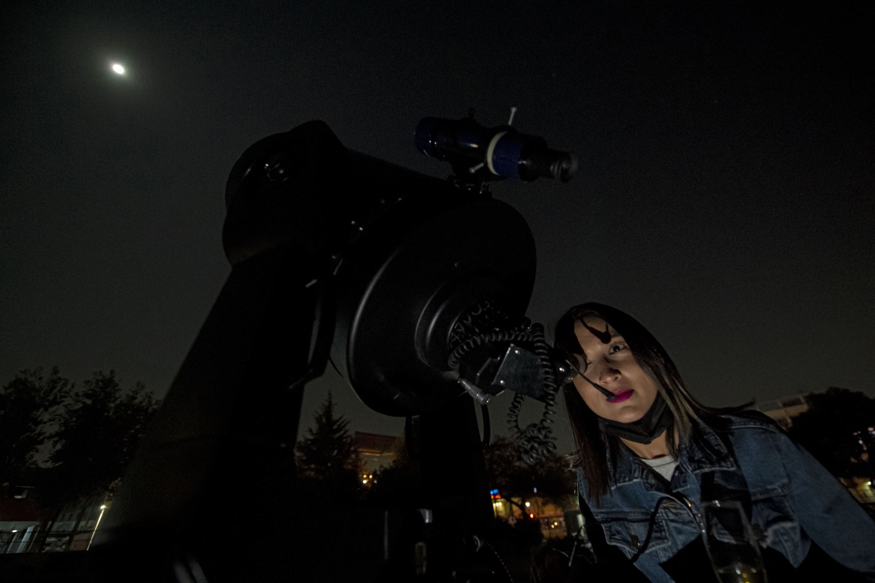 Una mujer mira la luna antes de un eclipse lunar total rojo sangre en Santiago, Chile. Foto: AFP