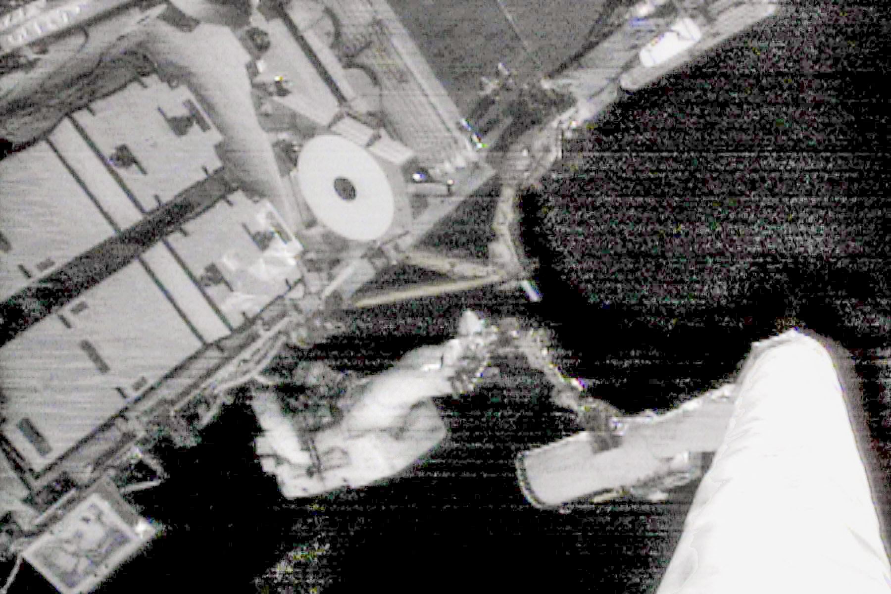 El tripulante del transbordador espacial estadounidense Endeavour, EE. UU., Carlos Noriega, trabaja desde el brazo robótico del transbordador, el 3 de diciembre de 2000, conectando cables en el conjunto de armazón P-6 recién instalado en la Estación Espacial Internacional. Foto: AFP